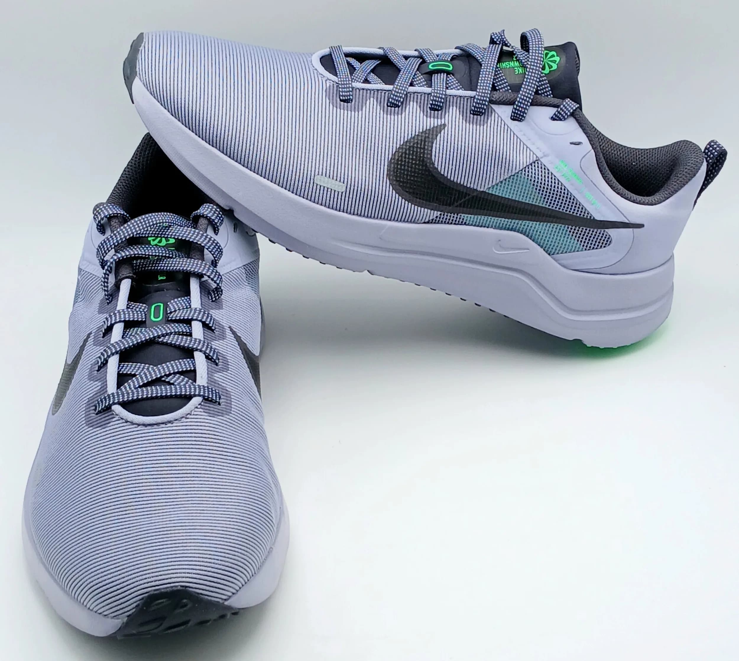 A pair of Nike Downshifter 12 running trainers in grey, with contrasting green accents. New in original box. Size UK 9, US size 10