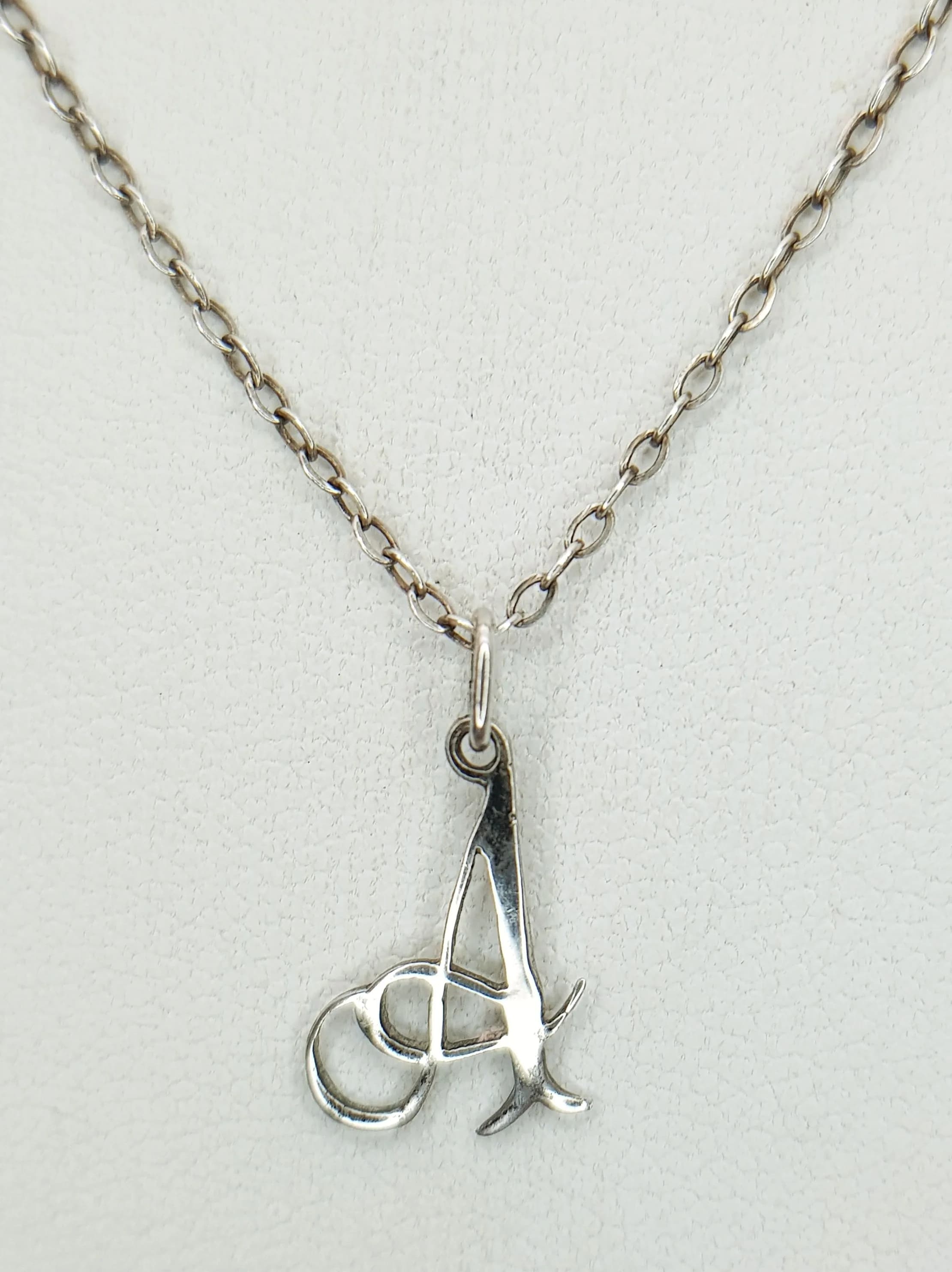 A Lovely 925 Sterling Silver Initial "A" Pendant Necklace - 44cm Length. Features an openwork initial "A" pendant on a fine silver chain. The pendant measures 1.5cm x 1cm. Gross weight 1.27 grams.