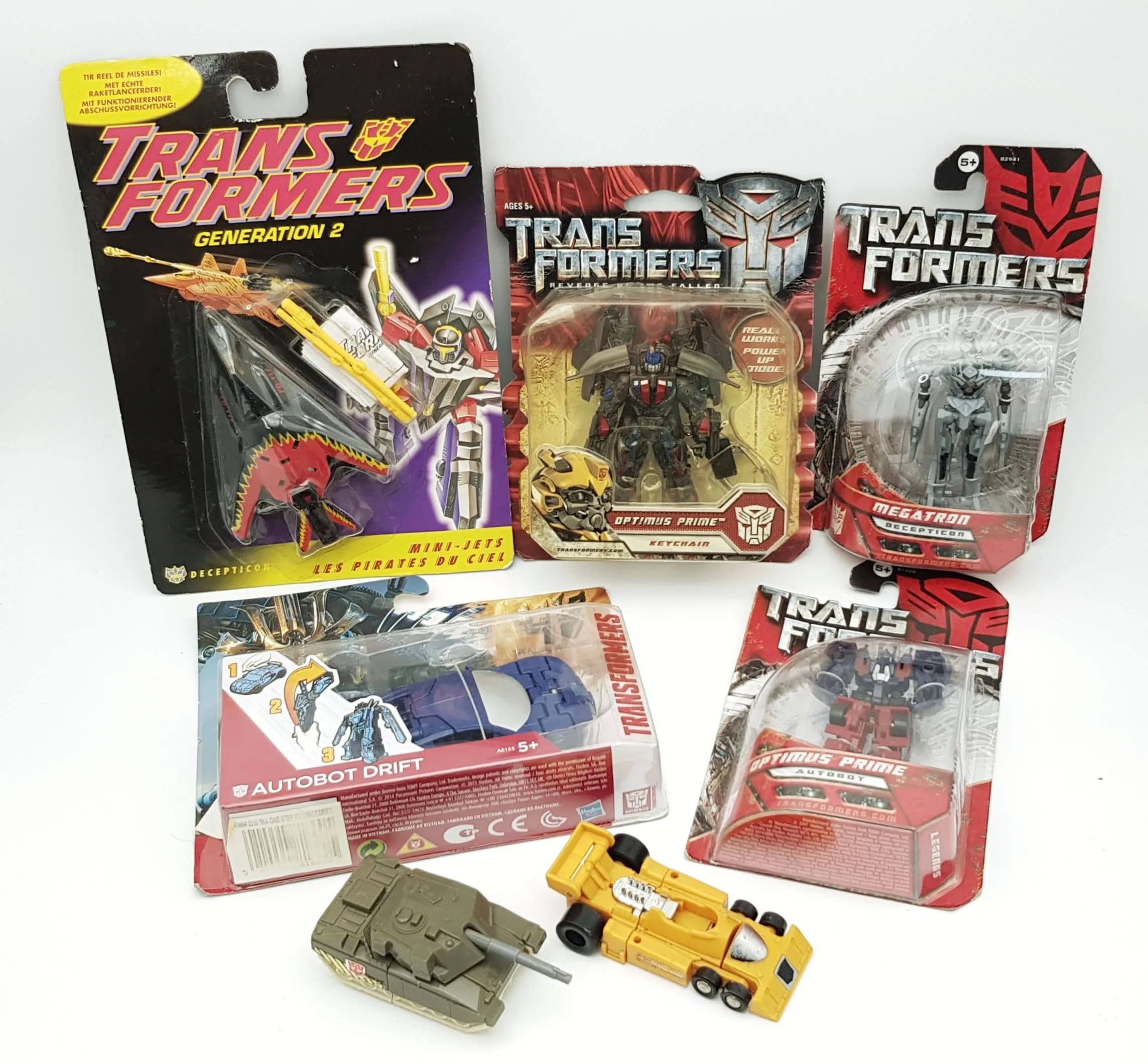 A collection of vintage Transformers by Hasbro. Still factory sealed. Comes with a rare European mini jet and two loose early models. Slight wear to packaging from storage, otherwise good condition.