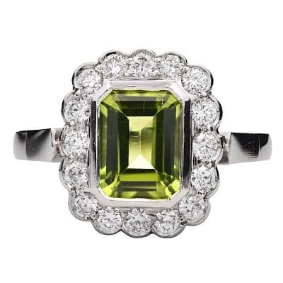 A Platinum Emerald Cut Green Tourmaline and Diamond Ring. Centre Green Tourmaline Weighing 1.62ct, surrounded by Diamonds Weighing Total 0.52ct. Total Ring Weight 8.11g, Size N. Ref: U2736