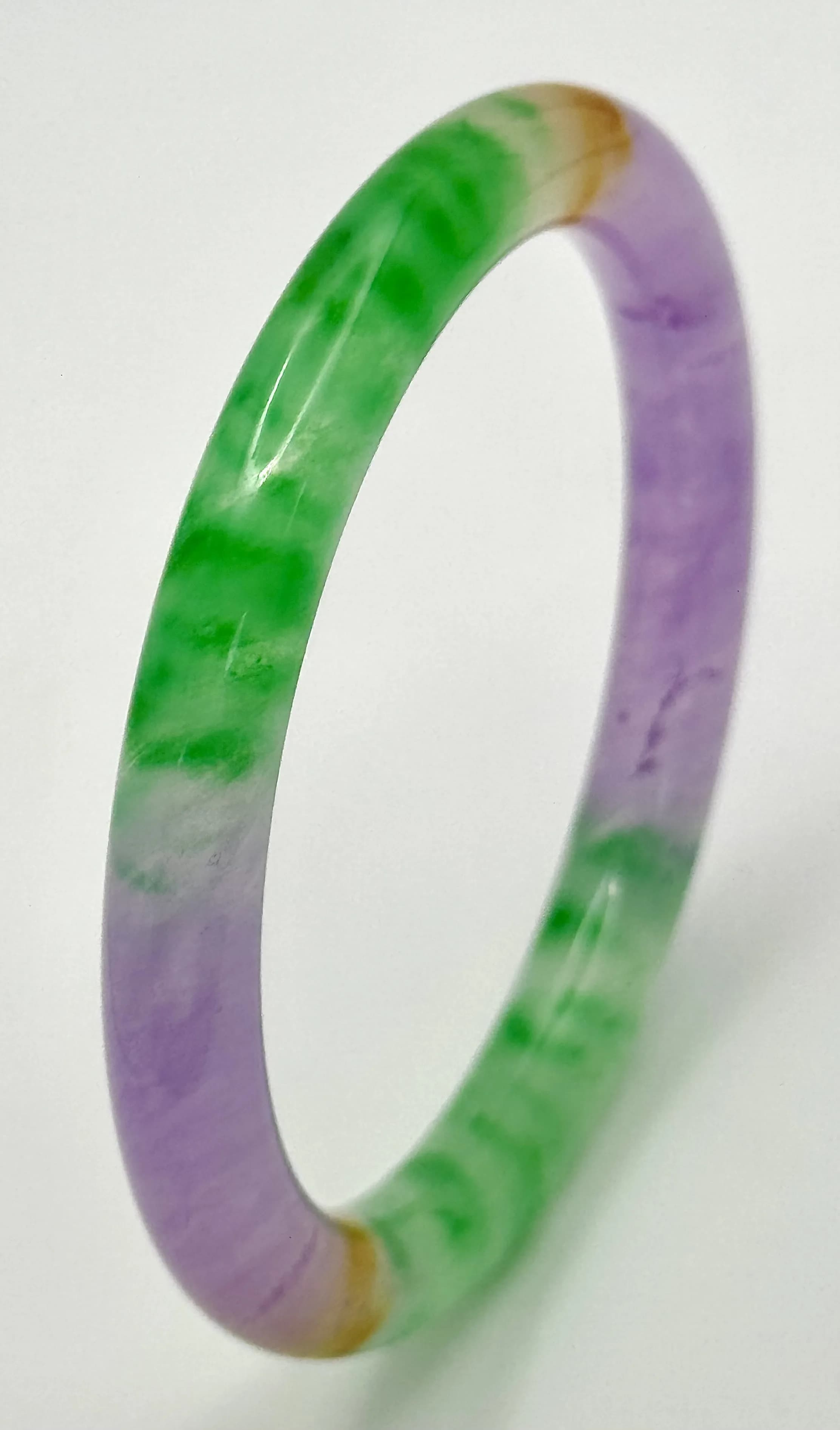 A Multi-Coloured Jade Bangle. 10mm width. 60mm inner diameter.