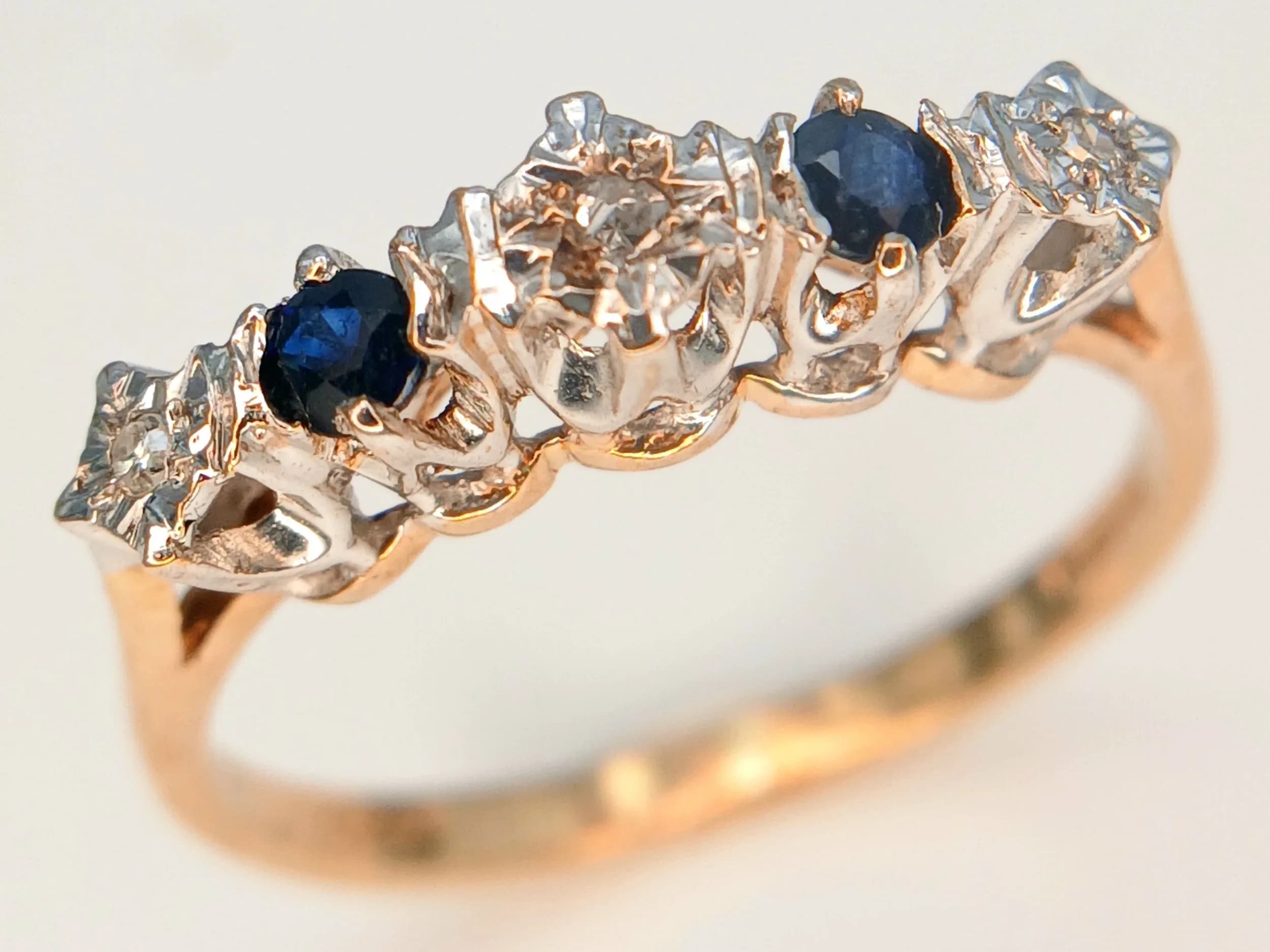 A 9K Yellow Gold, Sapphire and Diamond Five Stone Ring. Size N. 1.95g total weight.