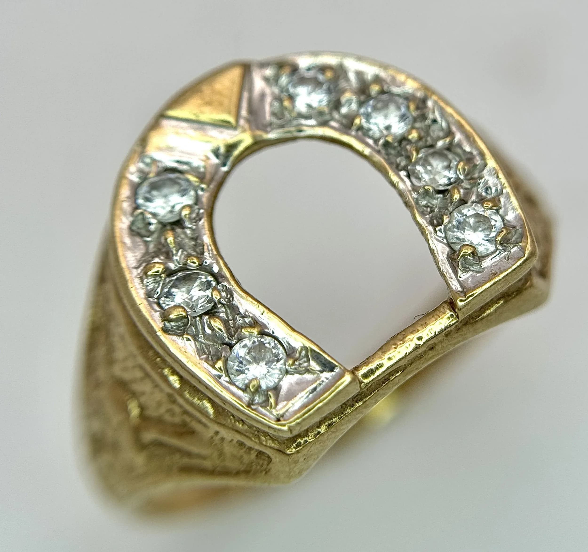 A 9K Yellow Gold and White Stone Lucky Horseshoe Ring. Size R 1/2. 4.2g.