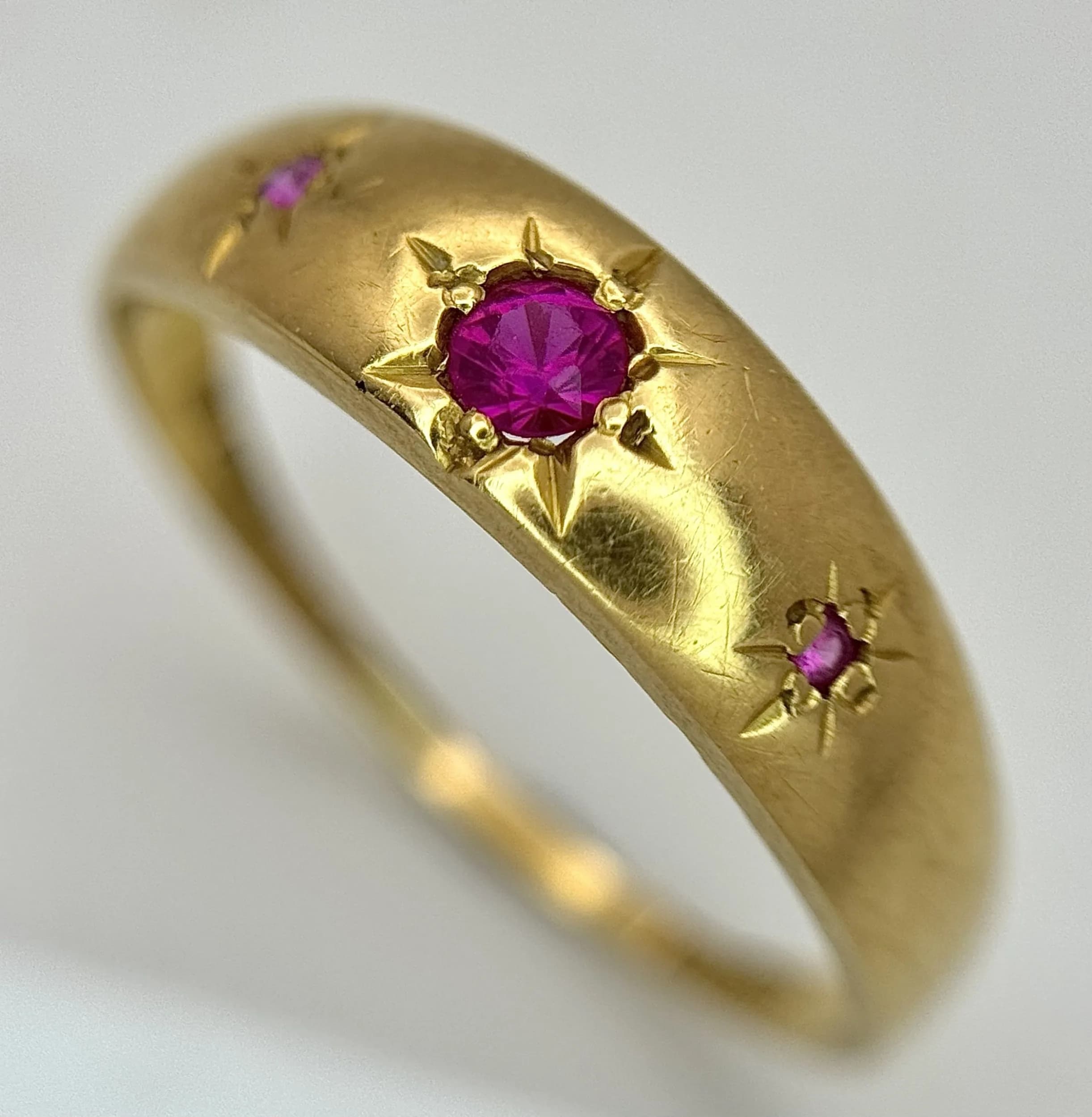 An Antique 18K Yellow Gold and Ruby Star Set Ring. Size N. 1.55g total weight.