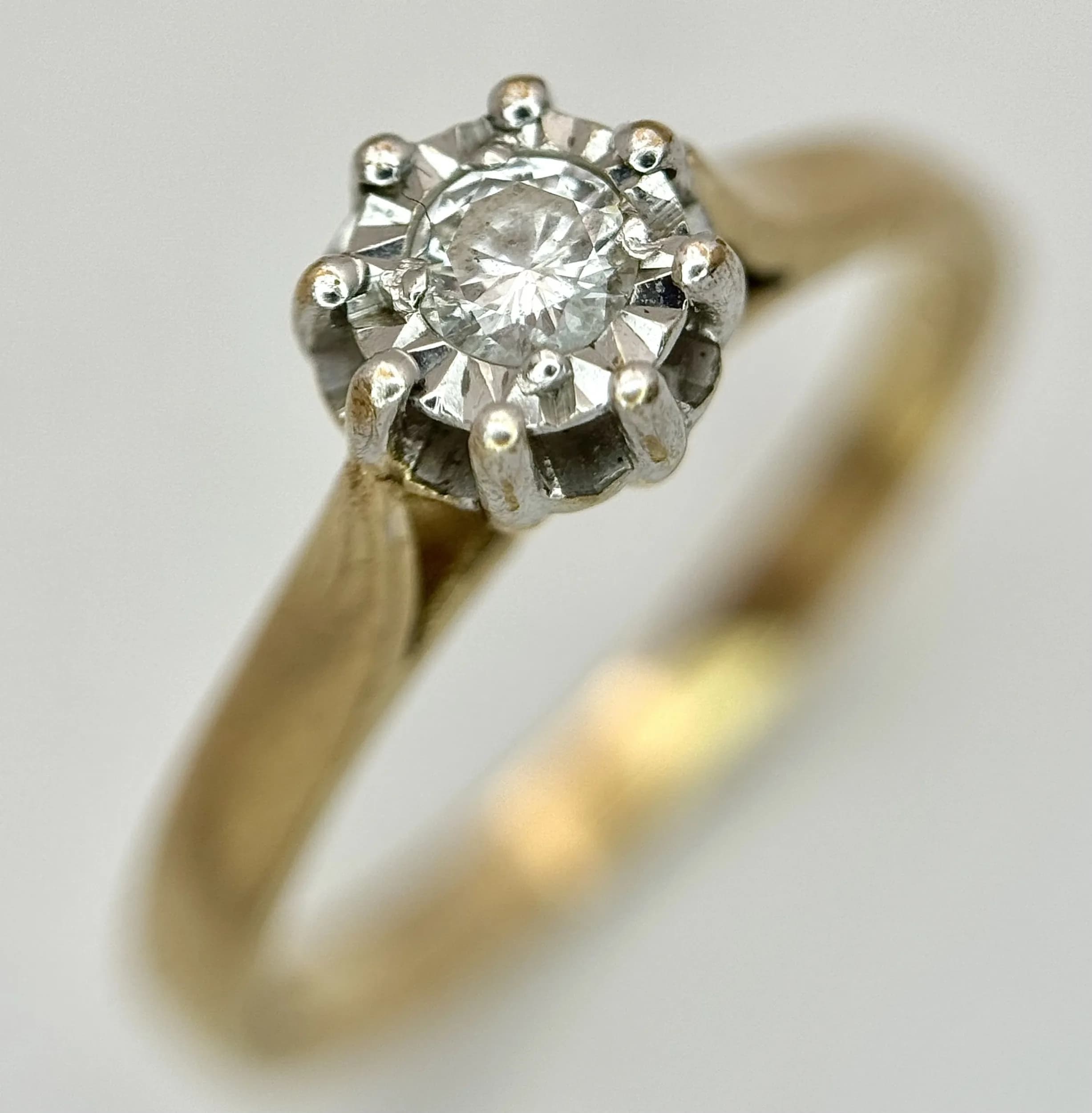 A 9K Yellow Gold Diamond Solitaire Ring. 0.15ct round brilliant cut diamond. Size P. 2.25g total weight.