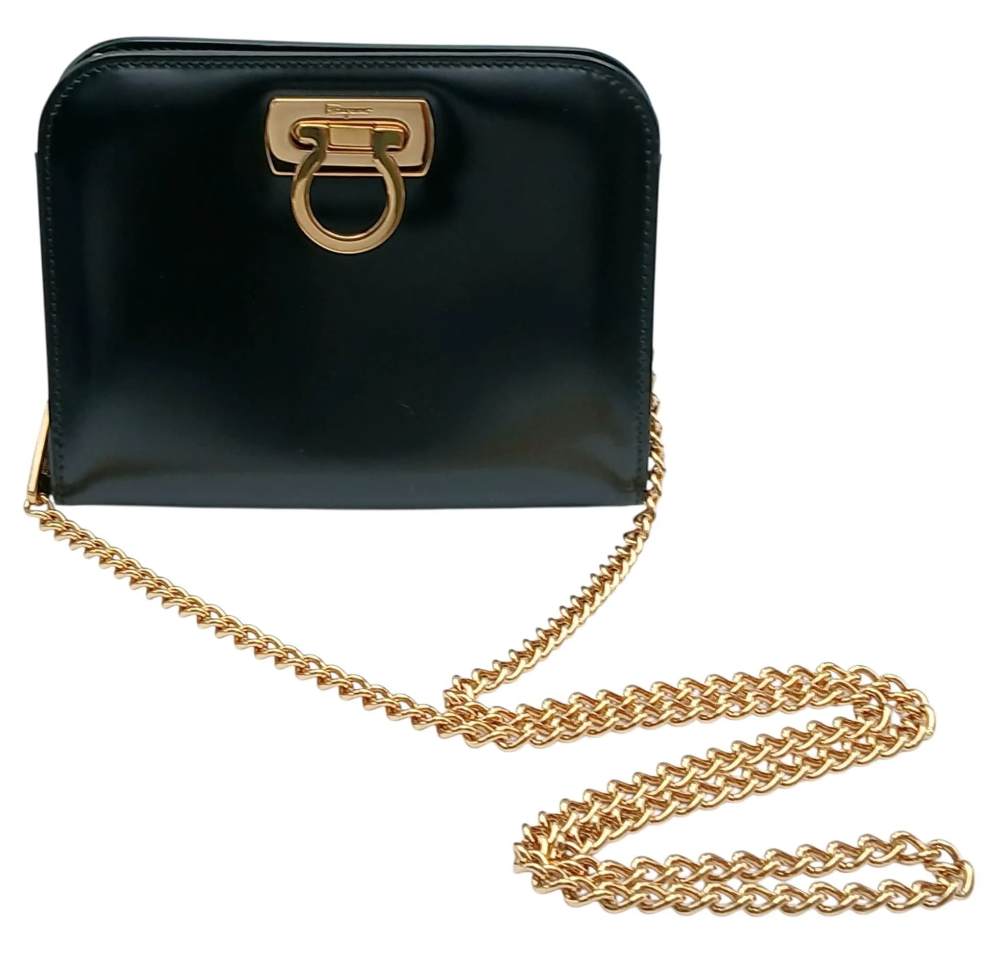 A Black Salvatore Ferragamo Gancini Chain Shoulder Bag. Black smooth leather exterior with gold-tone hardware, signature Gancini turn-lock closure and detachable gold-tone chain shoulder strap. Black leather interior with one main compartment. Comes with box, dust cover bag and tags. Approx. 16.5cm length x 12.5cm height x 5.7cm depth. Light scratches to the exterior but in good overall condition. Please see photos or request a condition report. Ref: 23692.
