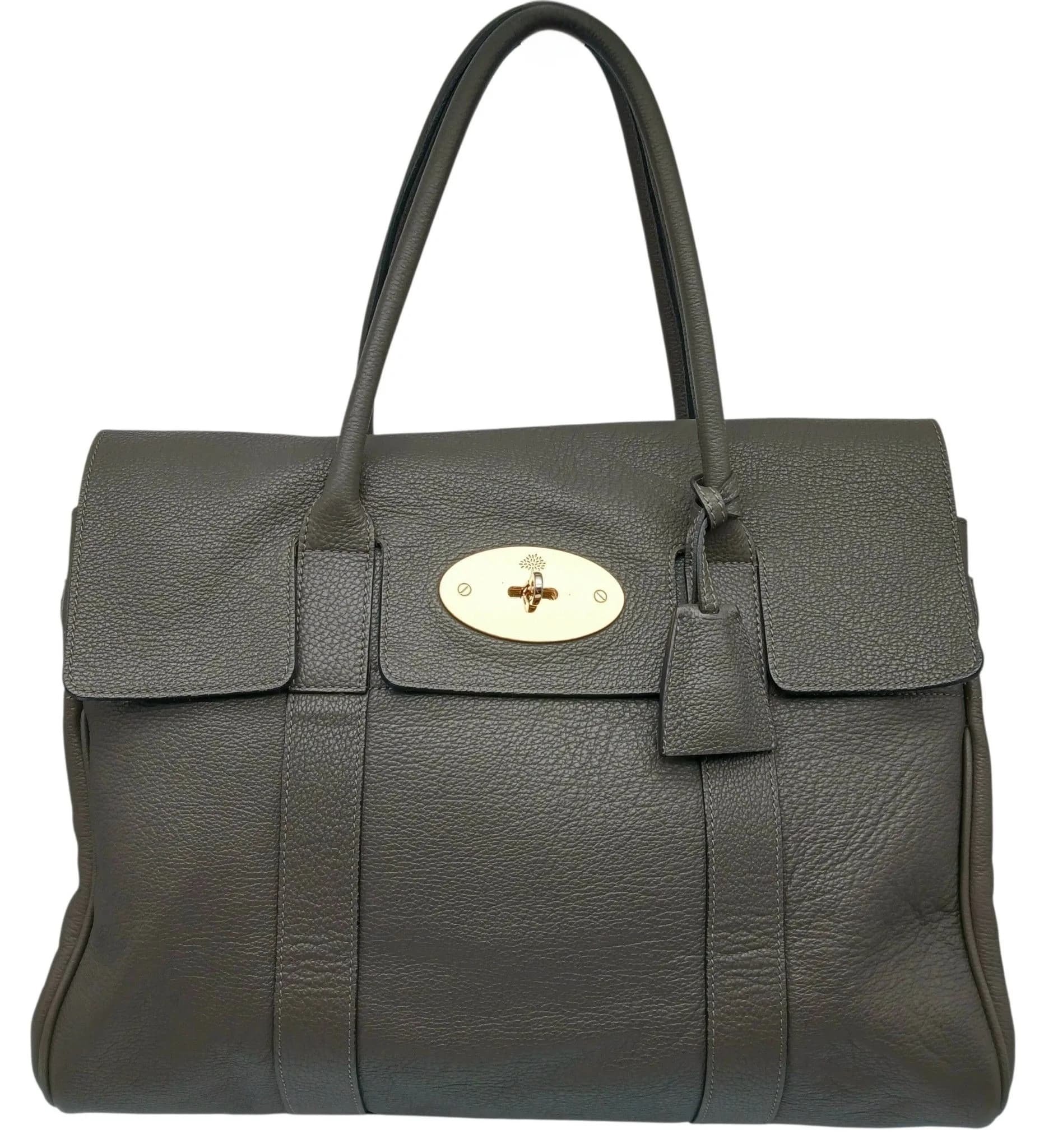 A Mulberry Bayswater Handbag. Charcoal grained leather exterior with gold-tone hardware, signature Postman’s Lock closure, double rolled leather top handles, protective base studs, hanging clochette and padlock. Grey suede interior with one main compartment, adjustable belt detail, a zipped inner side pocket and two open inner side pockets. Comes with a dust cover bag. Approx. 36.5cm length x 25cm height x 16cm depth. Signs of wear to the corners, light creasing and an approx. 1cm glitter mark to the back exterior. Please see photos or request a condition report. Ref: 29770.