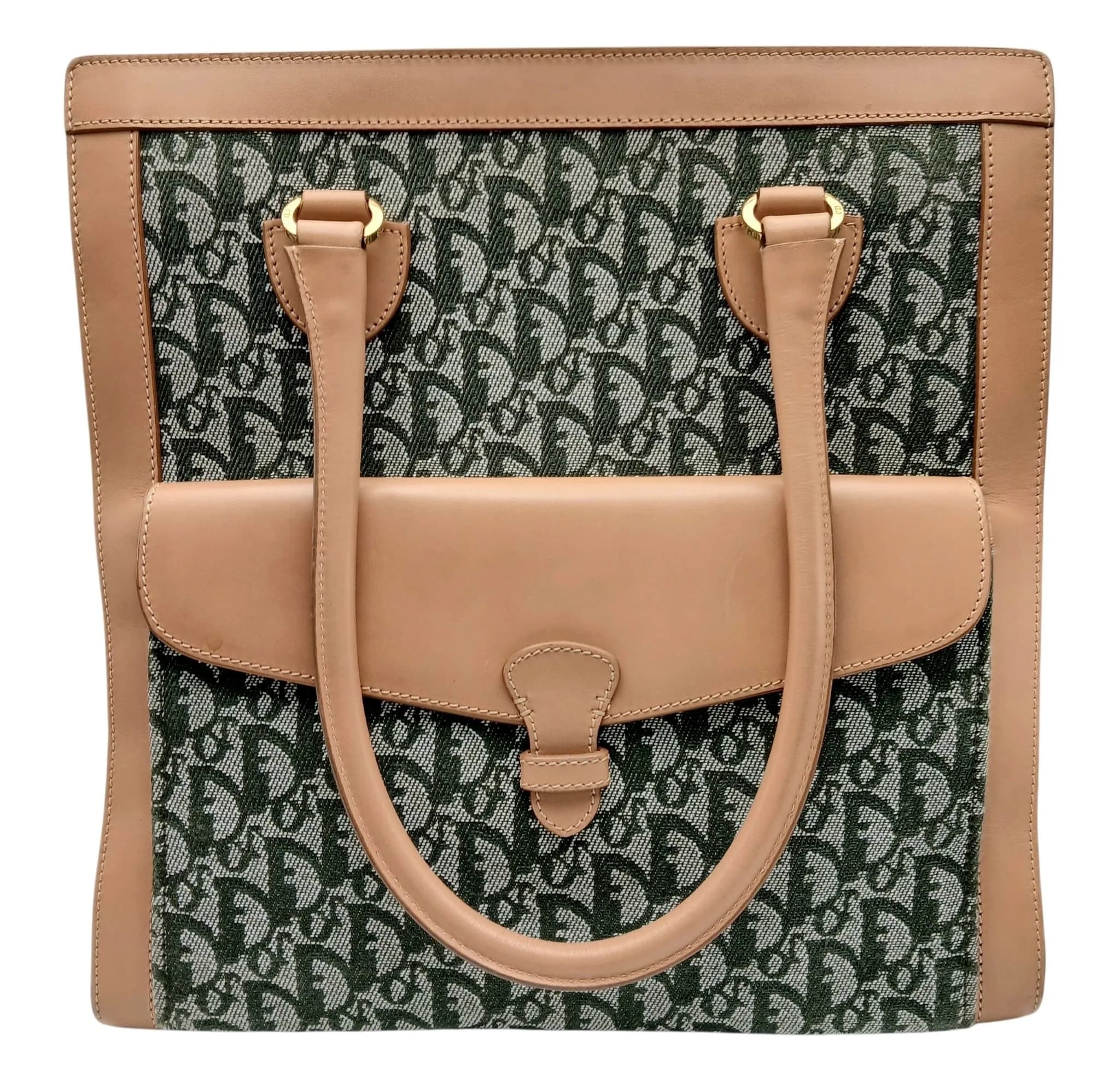 A Christian Dior Oblique Canvas Tote Bag. Green Dior Oblique monogram canvas exterior with tan leather trim, gold-tone hardware, protective base studs, double leather shoulder straps and a large front flap pocket with tab closure. Green textile interior with two main compartments divided by a central zipped compartment, two open inner side pockets and one zipped inner side pocket. Approx. 32.7cm length x 34cm height. A few stains to the base canvas and exterior - Please see photos or request a condition report. Ref: 27223.