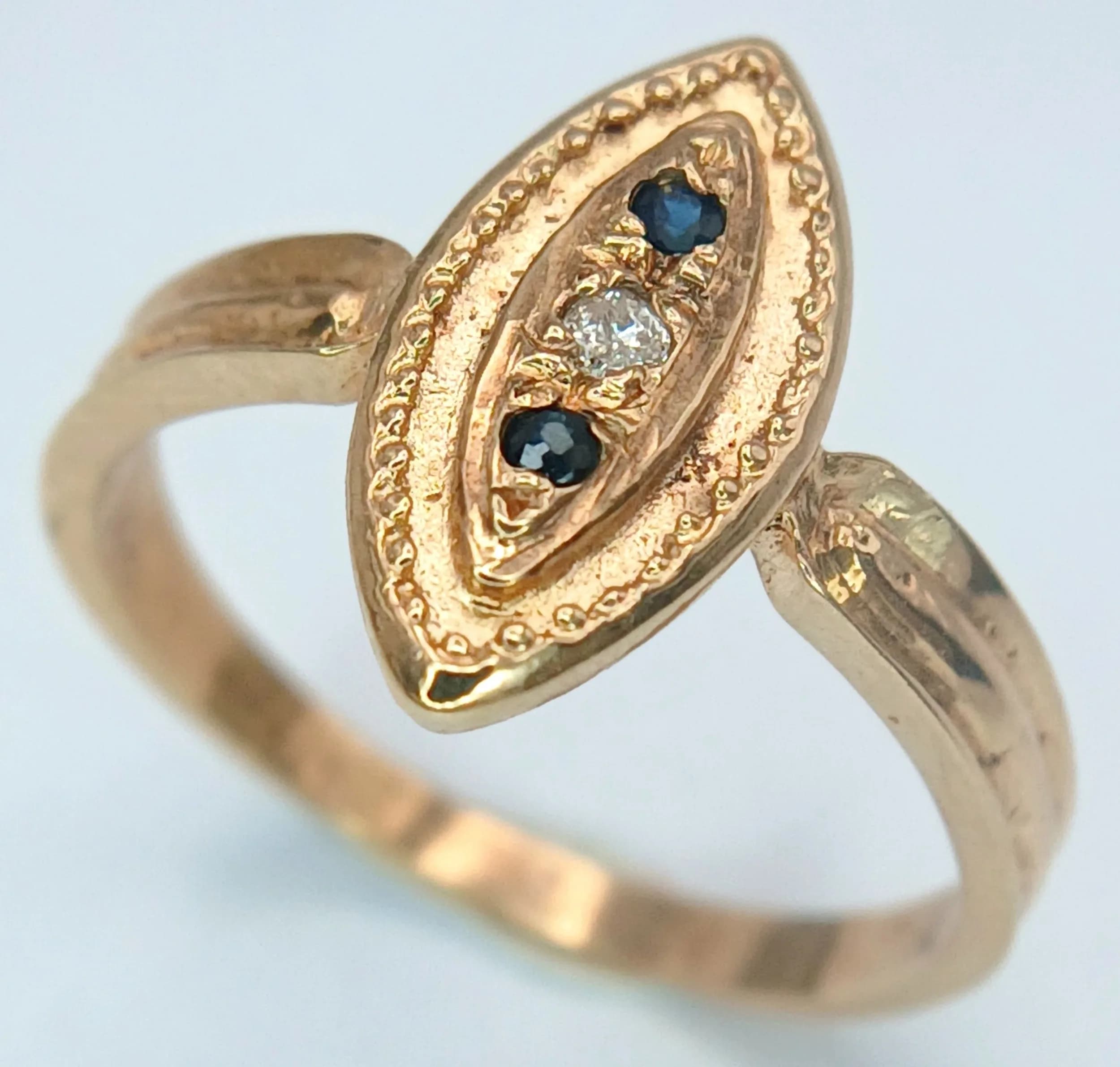An Antique Style 9K Yellow Gold, Garnet and Diamond Ring in Marquise Form. Size M. 2.05g total weight.