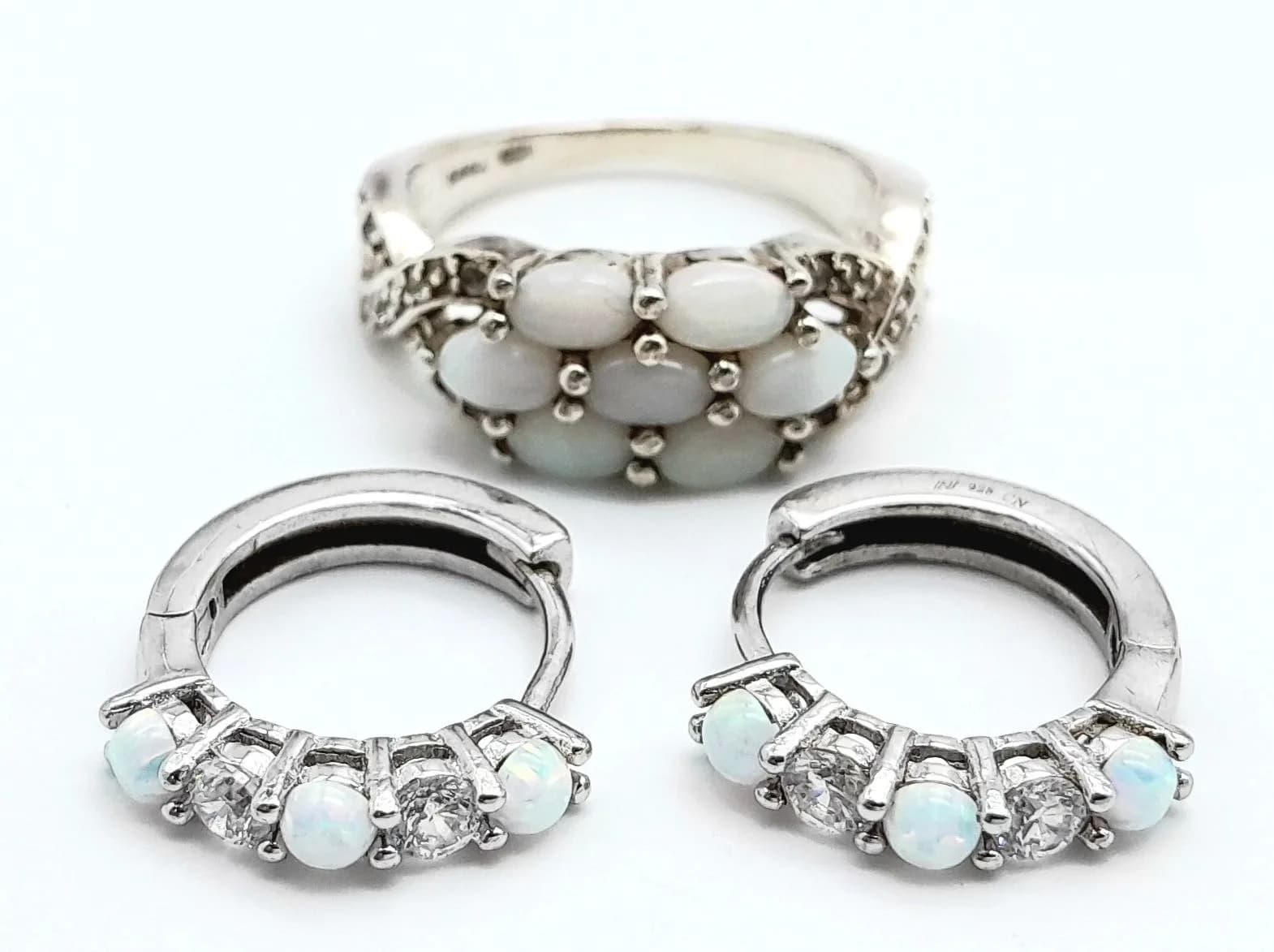 A Pretty Sterling Silver Opal and White Topaz Ring and Earrings Combination. The Ring is a size Q, measures 8mm wide at the Crown and has a gross weight of 4.42 grams. The Earrings measure 1.7cm Length and are set with 3mm length opals.
