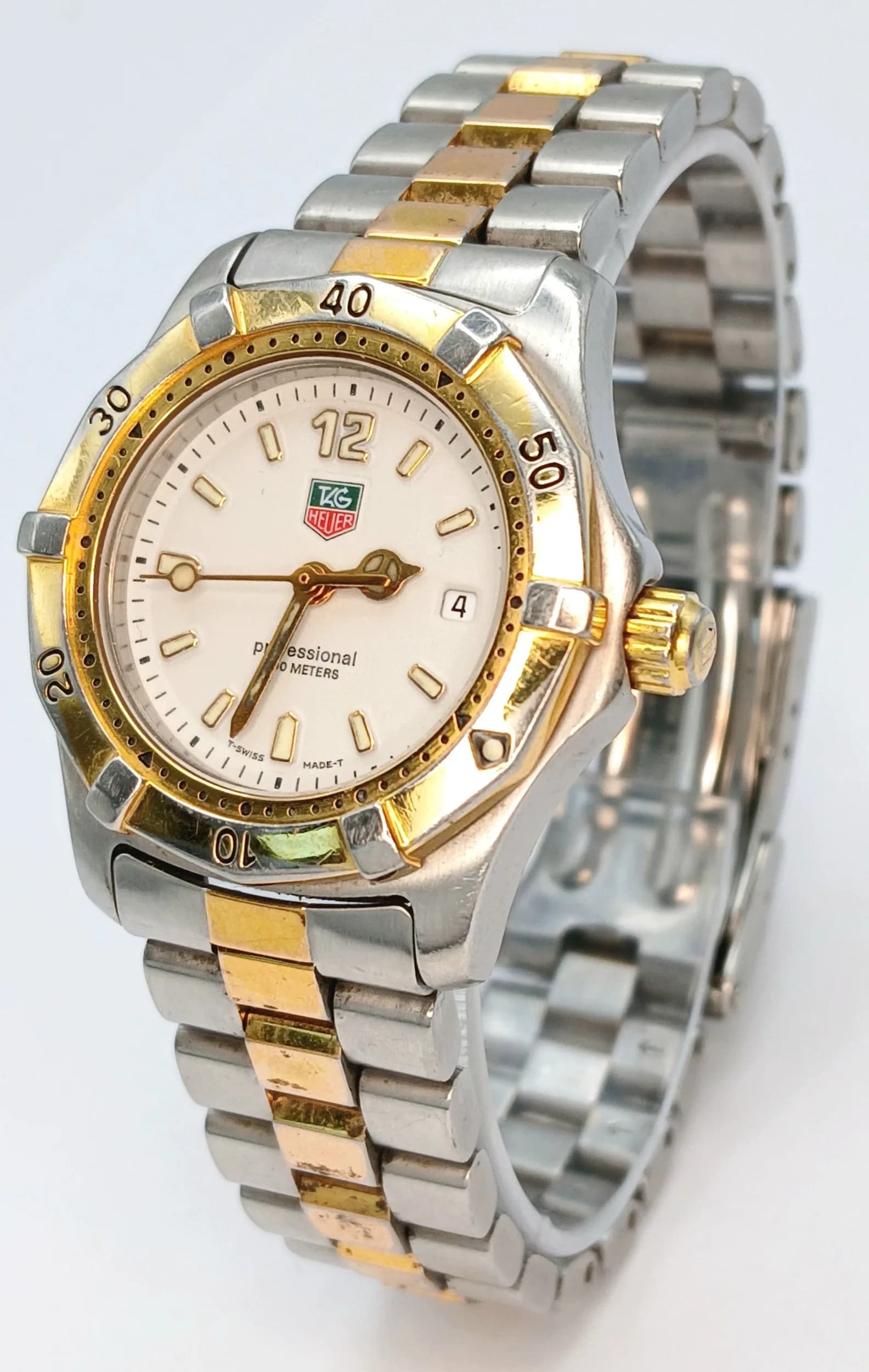 A Tag Heuer Professional Quartz Ladies Watch. Two tone stainless steel bracelet and case - 28mm. White dial with date window. Water resistant to 200M. In working order.