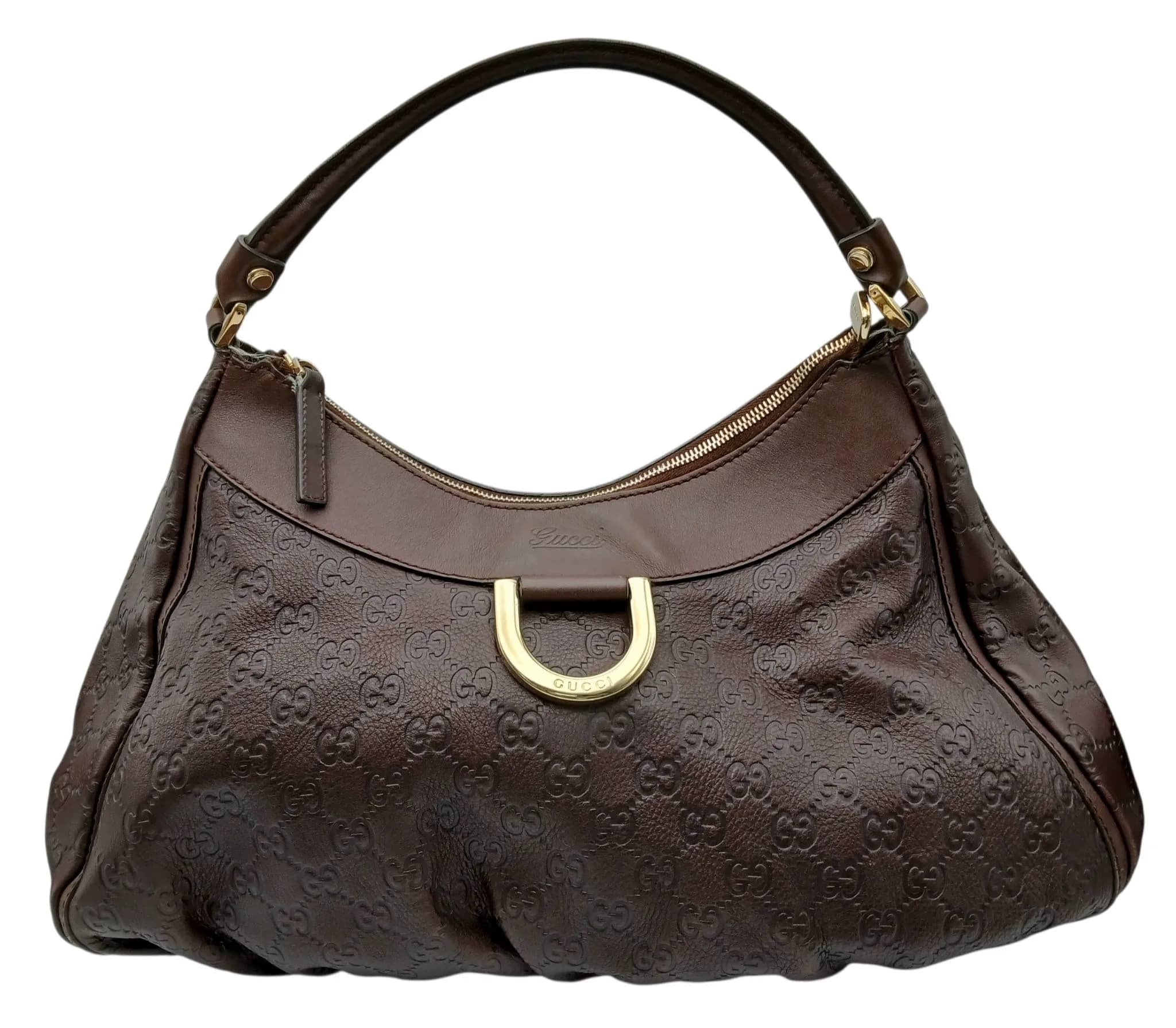 A Brown Gucci Abbey Guccissima Hobo Shoulder Bag. Brown Guccissima GG embossed leather exterior with gold-tone hardware, D-ring detail to the front and a single leather shoulder strap. Zip-top closure opens to a brown textile interior with one main compartment, a zipped inner side pocket and an open inner side pocket. Approx. 37cm length x 27cm height. Signs of wear to the corners and base, with minor stains to the interior. Please see photos or request a condition report. Ref: 29813.