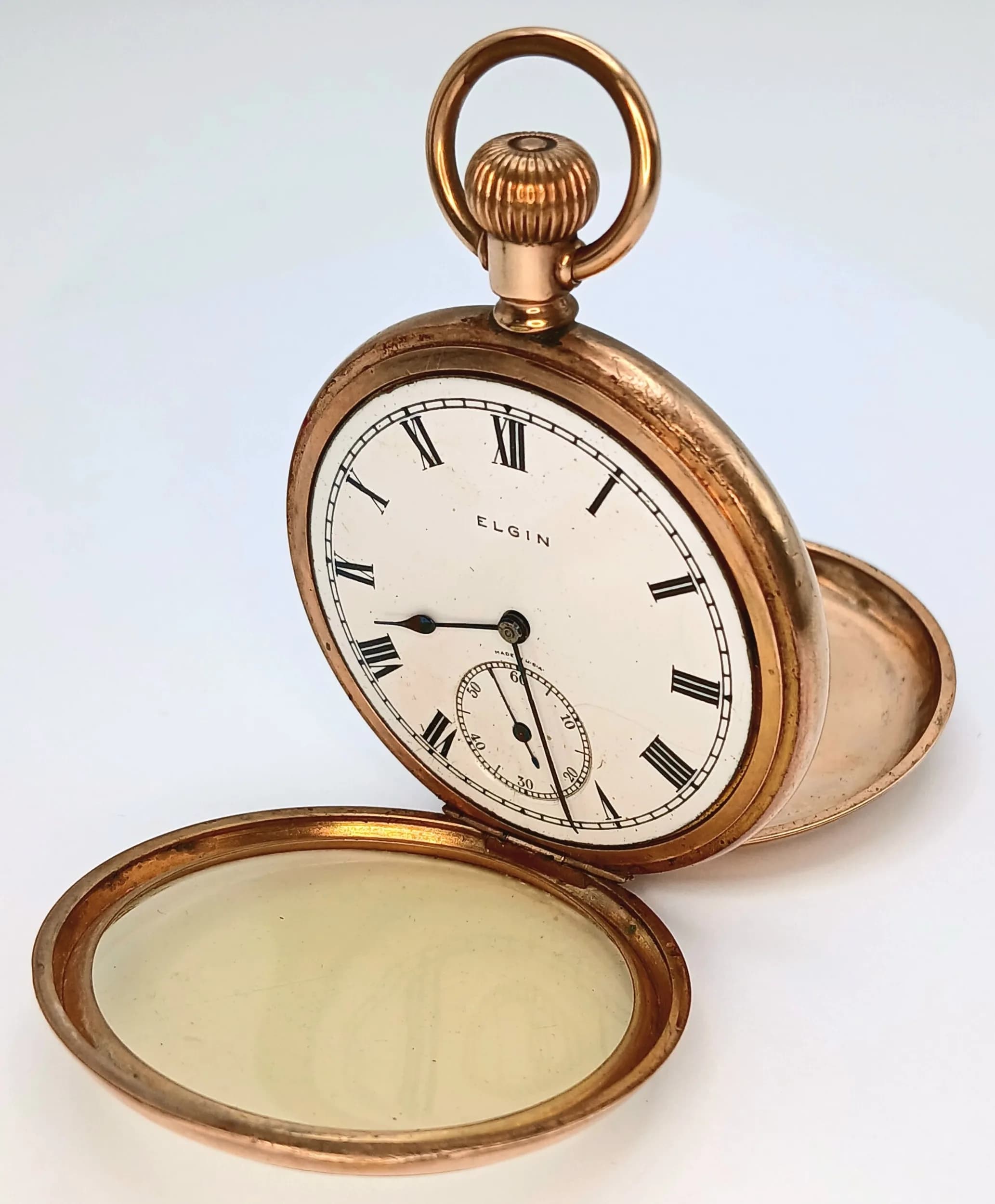 An Antique Gold Plated Elgin Pocket Watch. Top winder. Dial having Roman numeral markers and second sub dial. 50mm diameter case. In working order but because of age no guarantees.