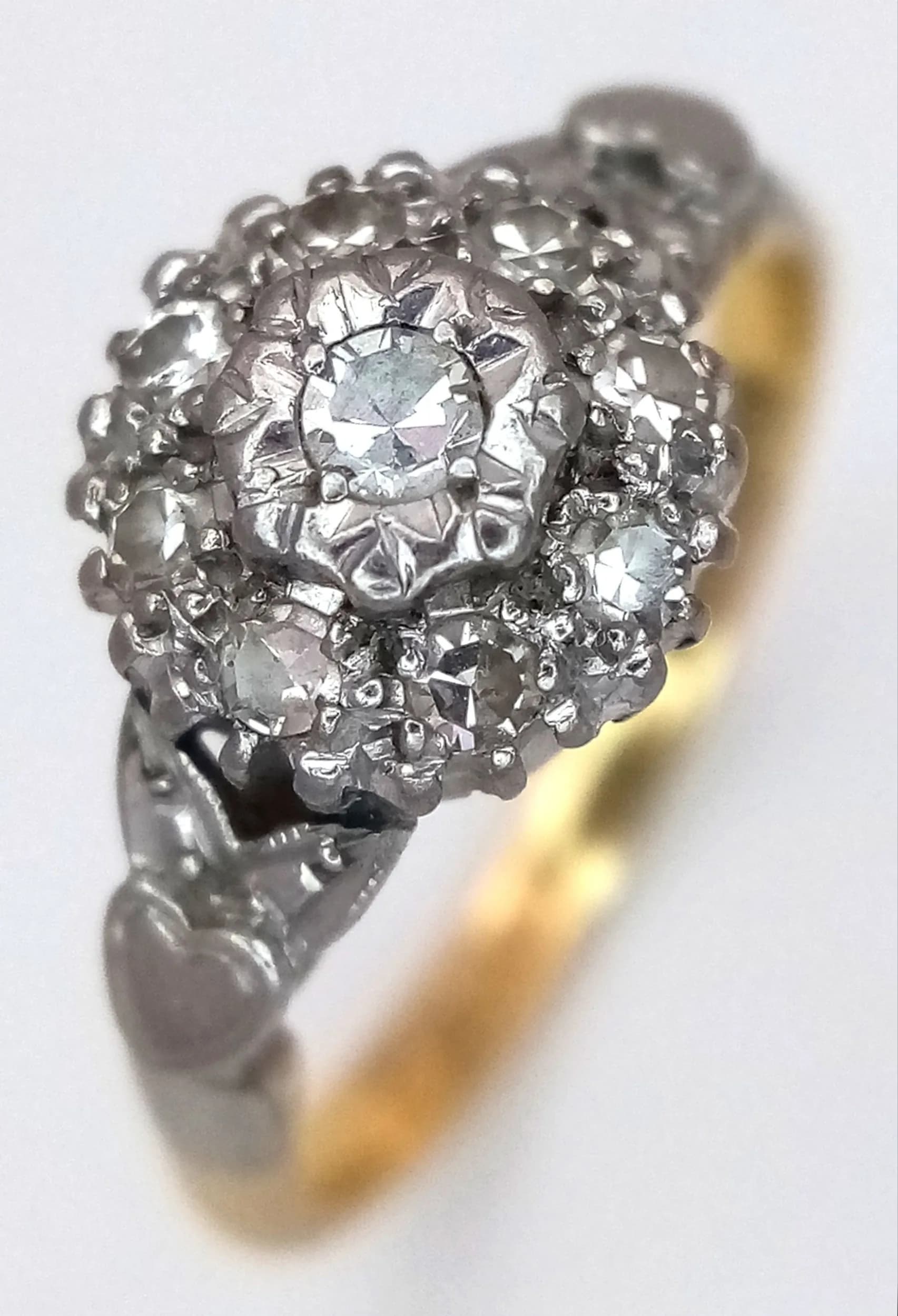 An 18K Yellow Gold and Platinum Diamond Tier Setting Cluster Ring. Circa 0.3ctw of round brilliant cut diamonds. Size K. 2.8g.