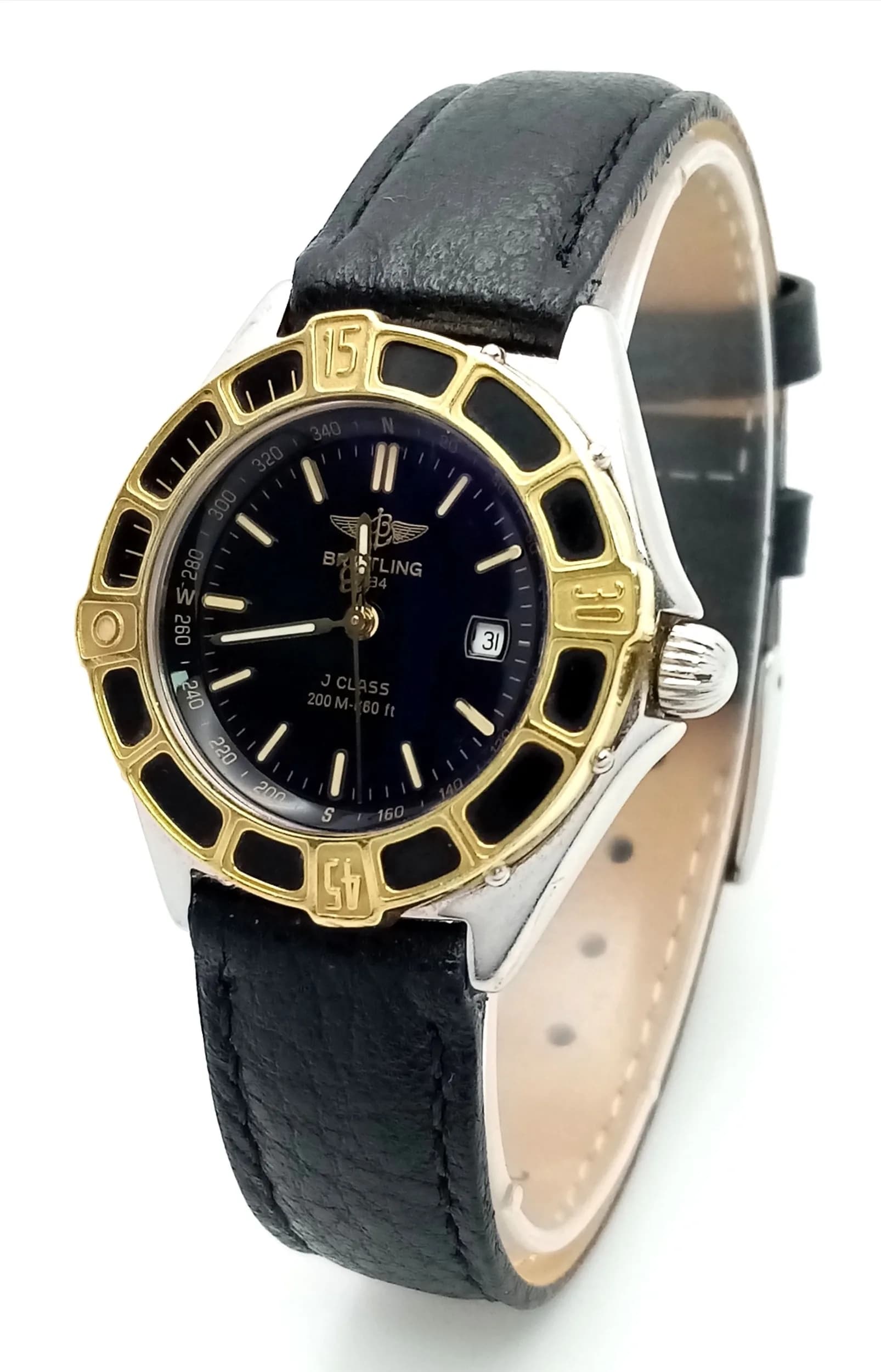 A Breitling J Class Ladies Quartz Watch. Black leather strap. Stainless steel case with gilded accents on rotating bezel. Black dial with date window. In working order. Ref: 029604.
