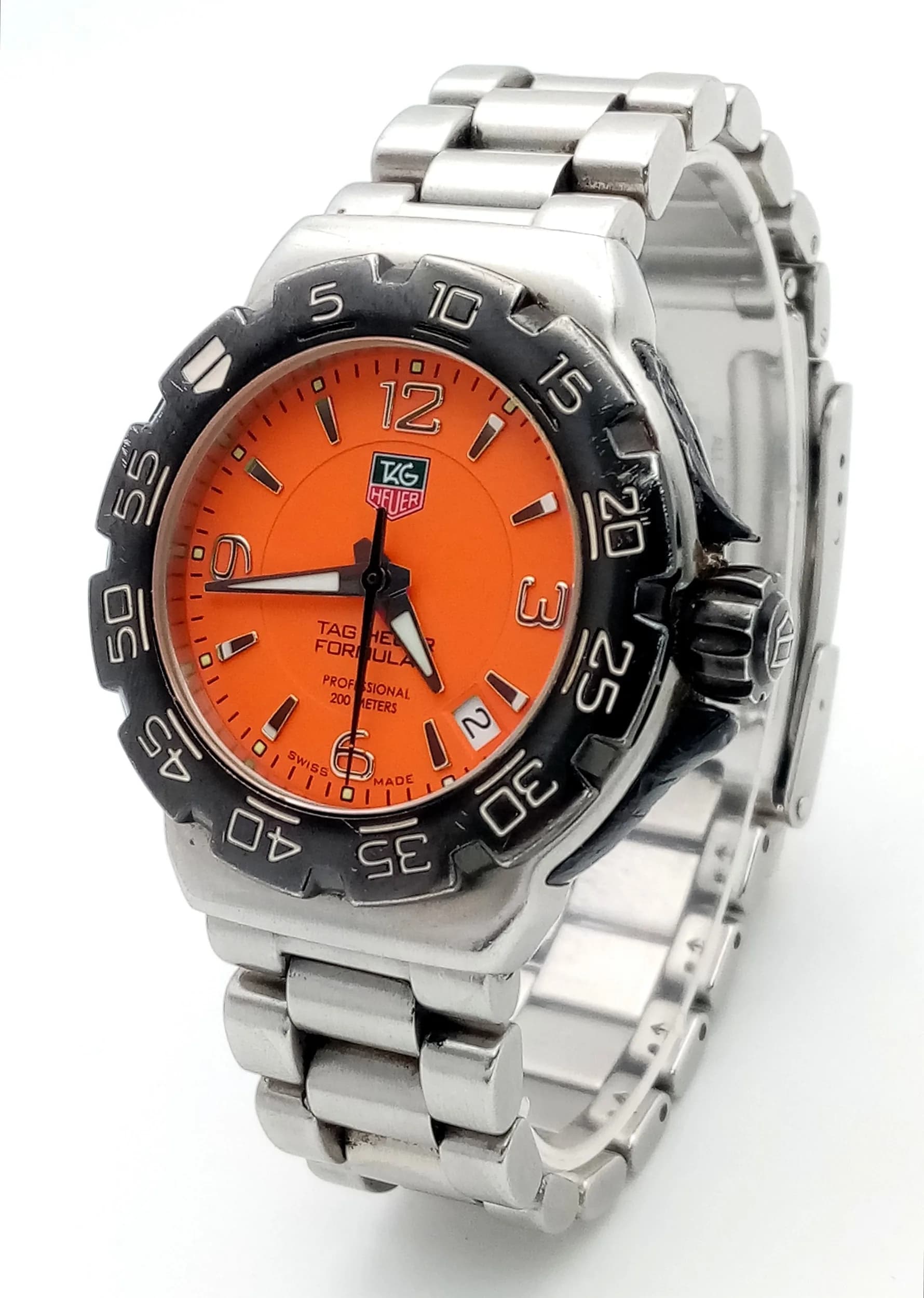 A Tag Heuer Formula 1 Quartz Ladies Watch. Stainless steel bracelet and case - 34mm. Orange dial with date window. I working order. Comes with spare links, case and booklet. Ref: 029830