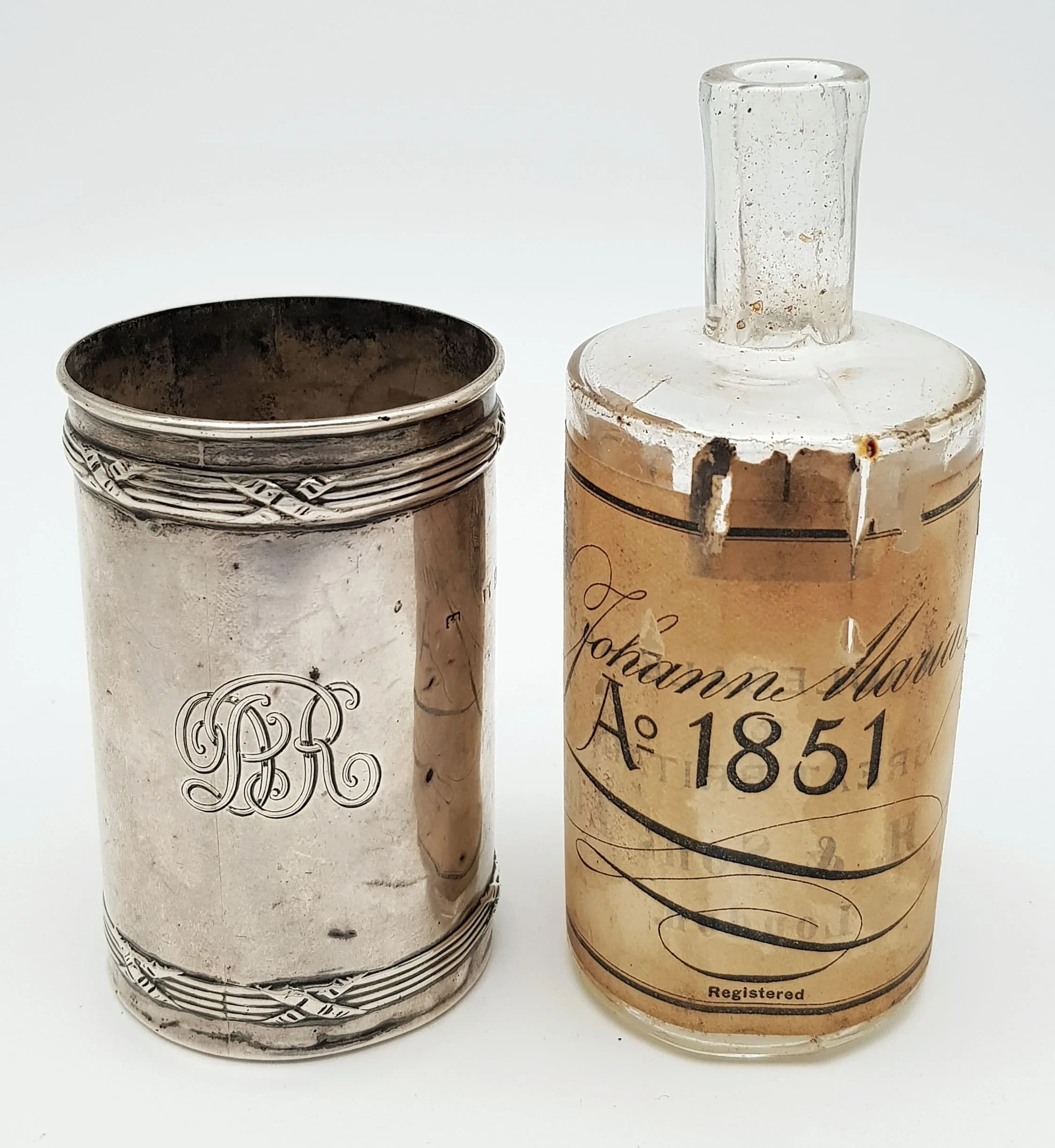 An Antique Cologne/Perfume Bottle with Silver Jacket. Cologne bottle from Johann Maria Farina who created the first Eau de Cologne. Silver jacket hallmarked Birmingham, 1909. 12cm tall bottle, 8.5cm tall jacket. 39.65g silver weight.