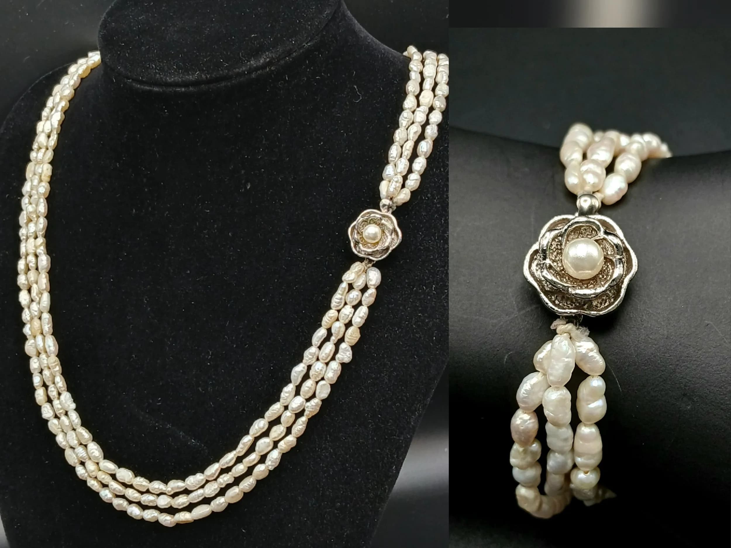 A Stunning Freshwater Pearl Multi-Strand Necklace and Bracelet Set. Comprising a three-strand necklace and bracelet, both set with irregular freshwater pearls and decorative silver-tone flower clasps. Necklace approx. 46cm length. Bracelet approx. 16cm length. Comes with a presentation case.