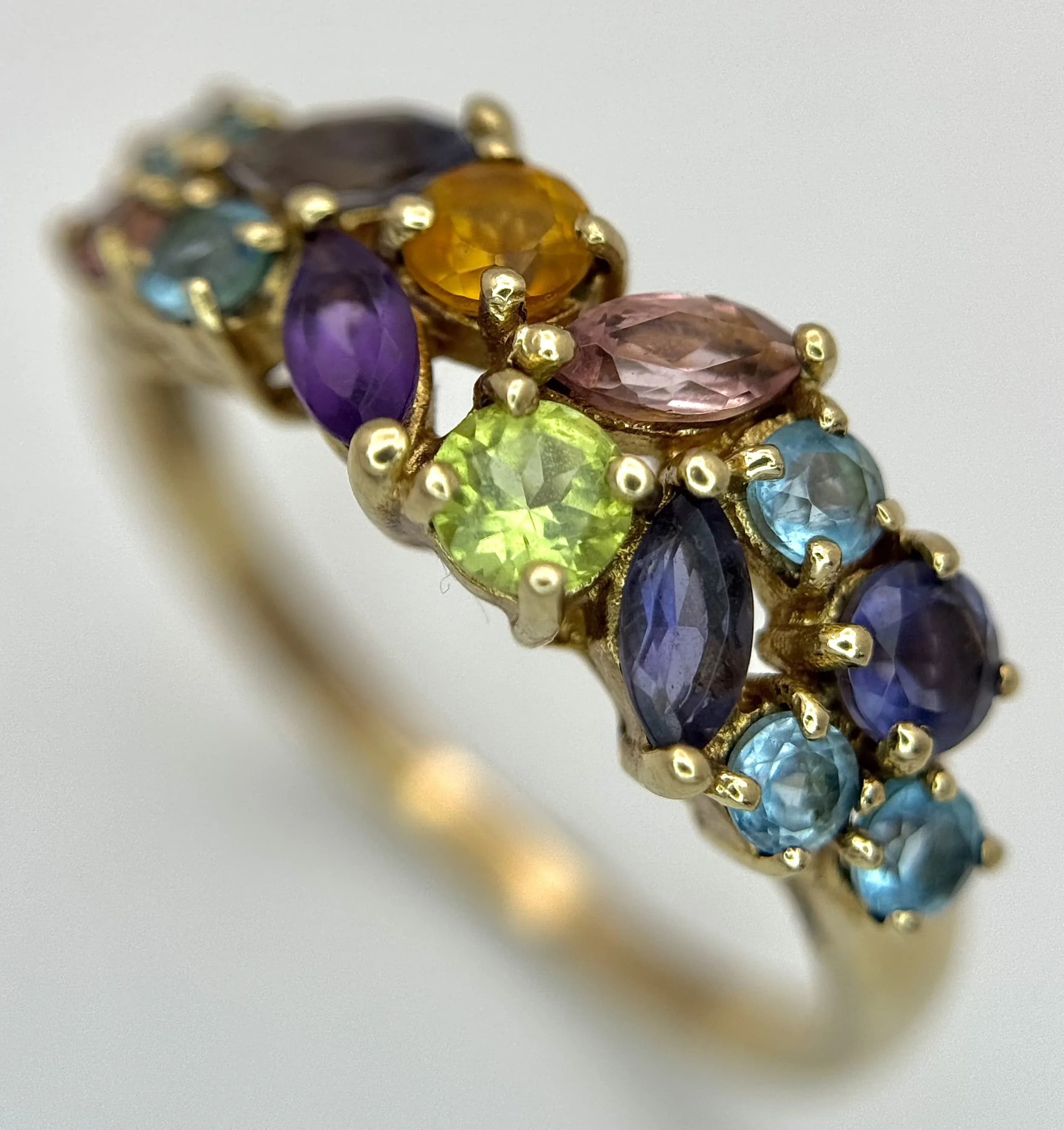 A 9K Yellow Gold Multi Gemstone Ring. Peridot, amethyst, topaz and citrine. Size T. 3g.