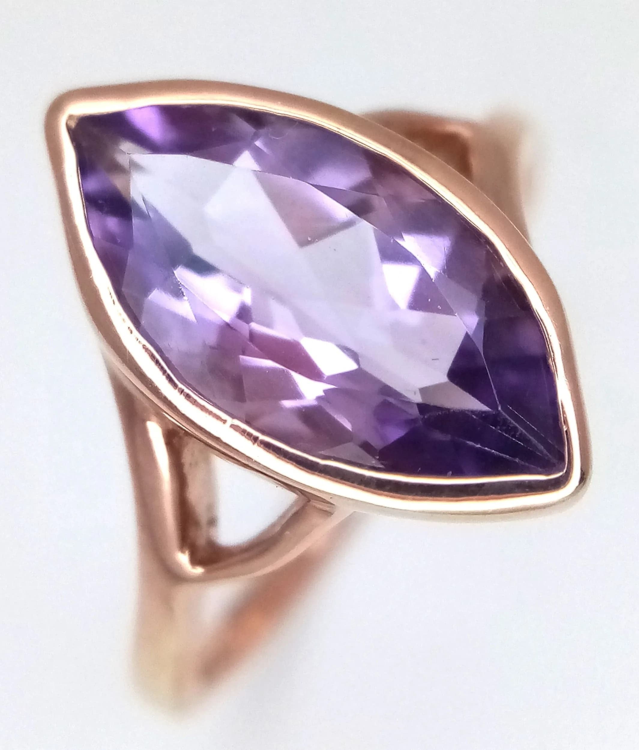 A Rose Gold Gilded Sterling Silver Marquise Cut Amethyst Ring Size N. The Ring is set with a 1.4cm Long Marquise Cut Amethyst and has a gross weight of 2.93 grams.