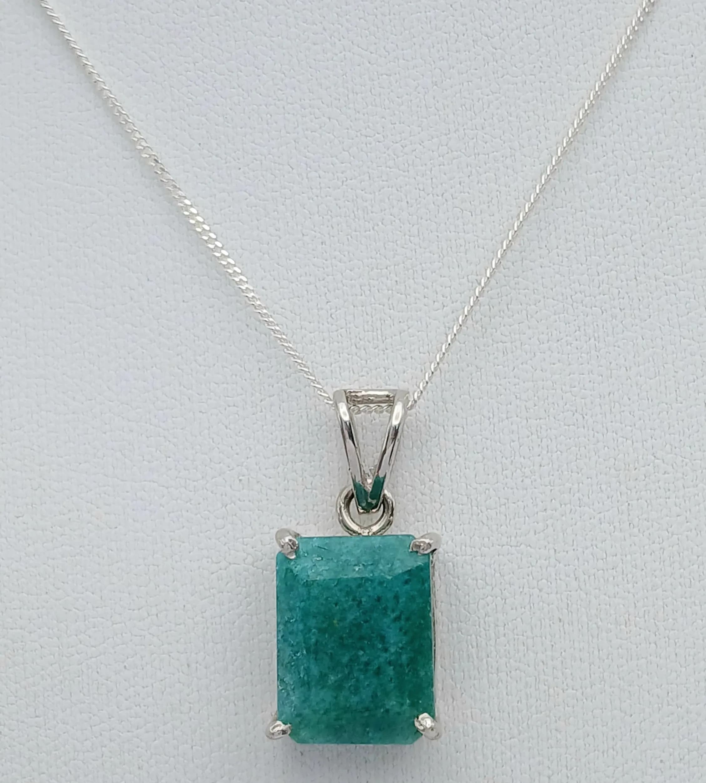 A Sterling Silver Certificated Natural Emerald Pendant Necklace. 46cm length chain. The Rectangle Cut Emerald measures 14 x 11mm and is 9 carat. The Necklace has a gross weight of 5.7 grams. Comes with Certificate of Authenticity.