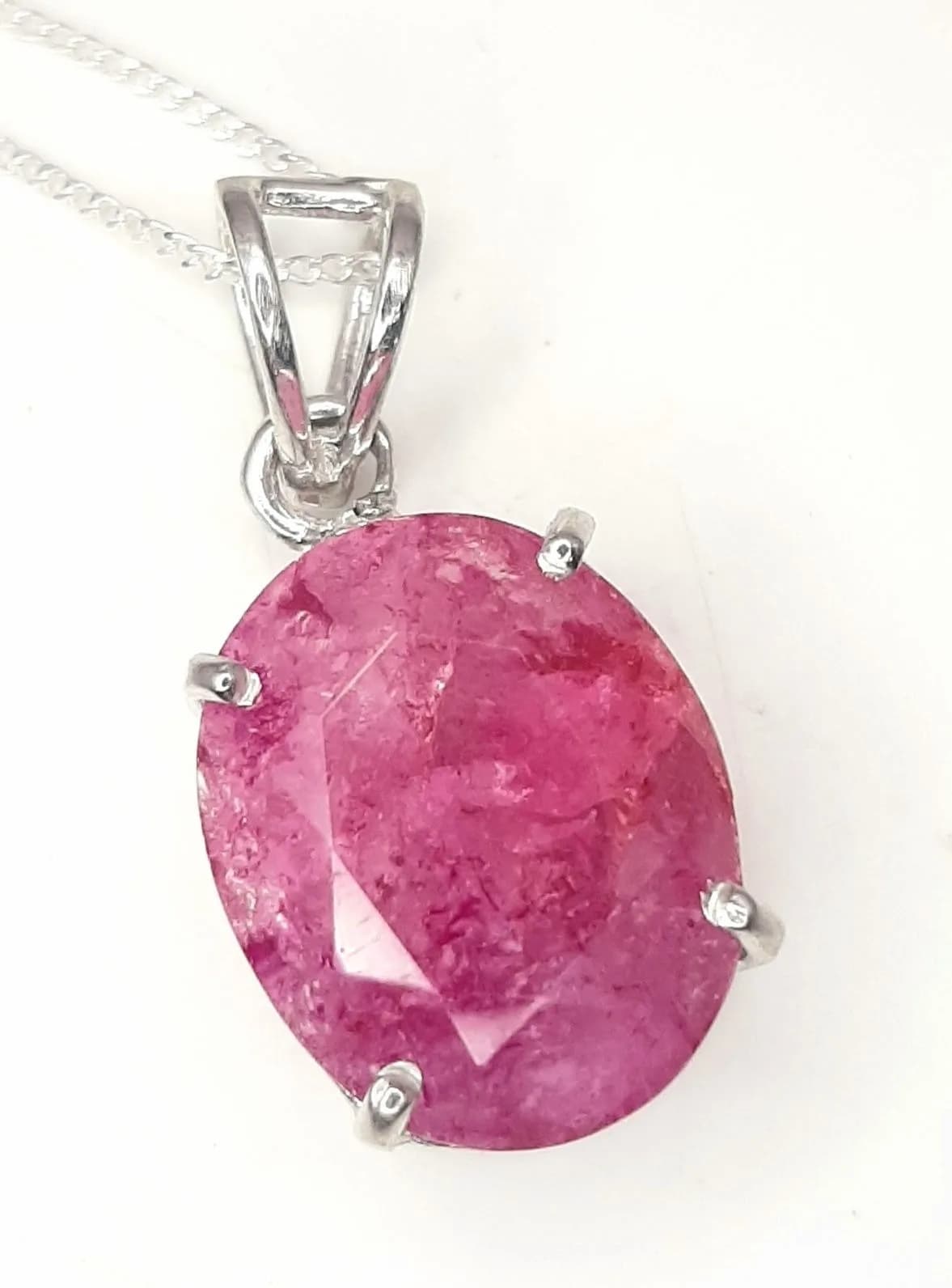 A Sterling Silver Certificated Natural Ruby Pendant Necklace. 46cm length chain. The Oval Cut Emerald measures 15 x 13mm and is 11.5 carat. The Necklace has a gross weight of 5.62 grams. Comes with Certificate of Authenticity.