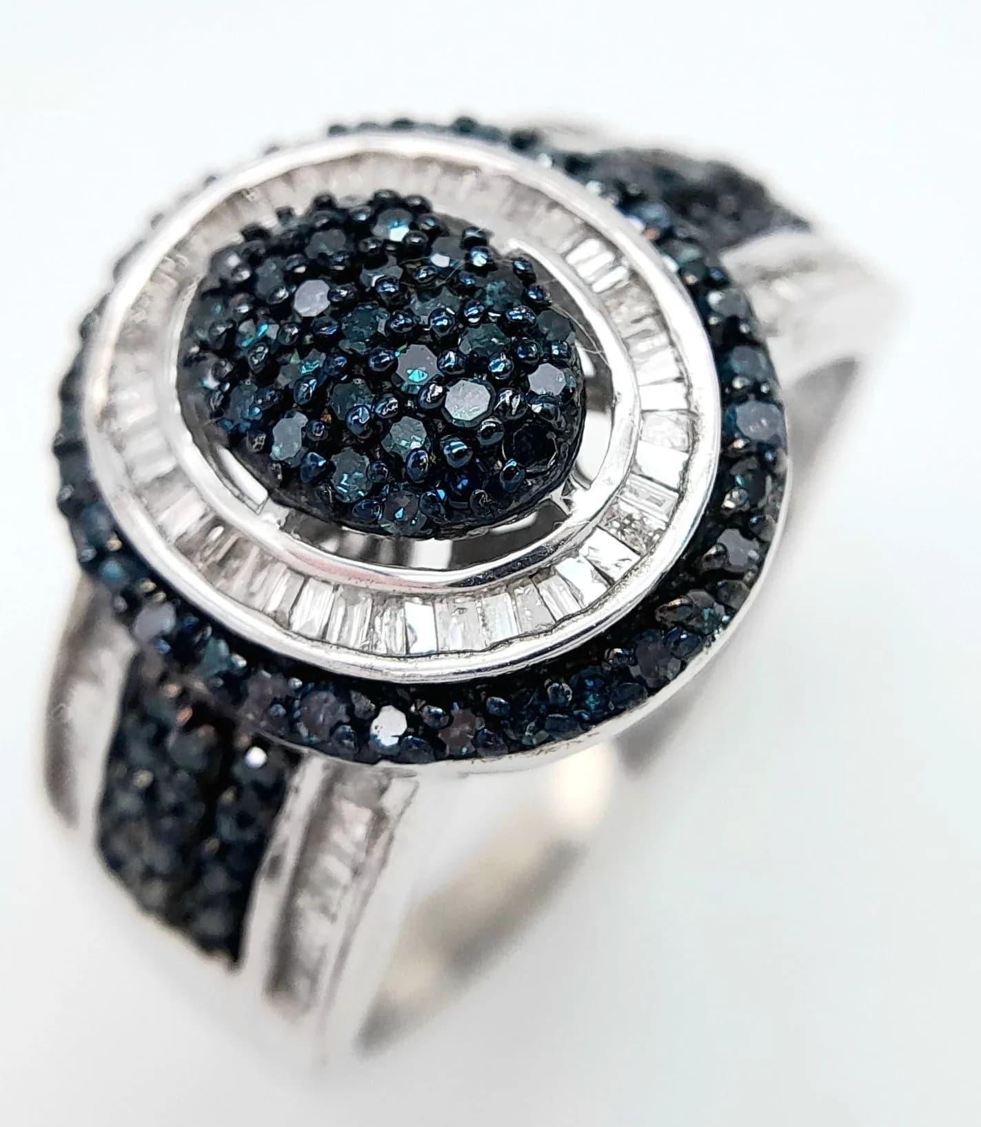 An Impressive Sterling Silver Blue and White Diamond Set Ring Size W. Gallery underside with the upper Crown measuring 1.6cm Length. Gross weight 6.98 grams.