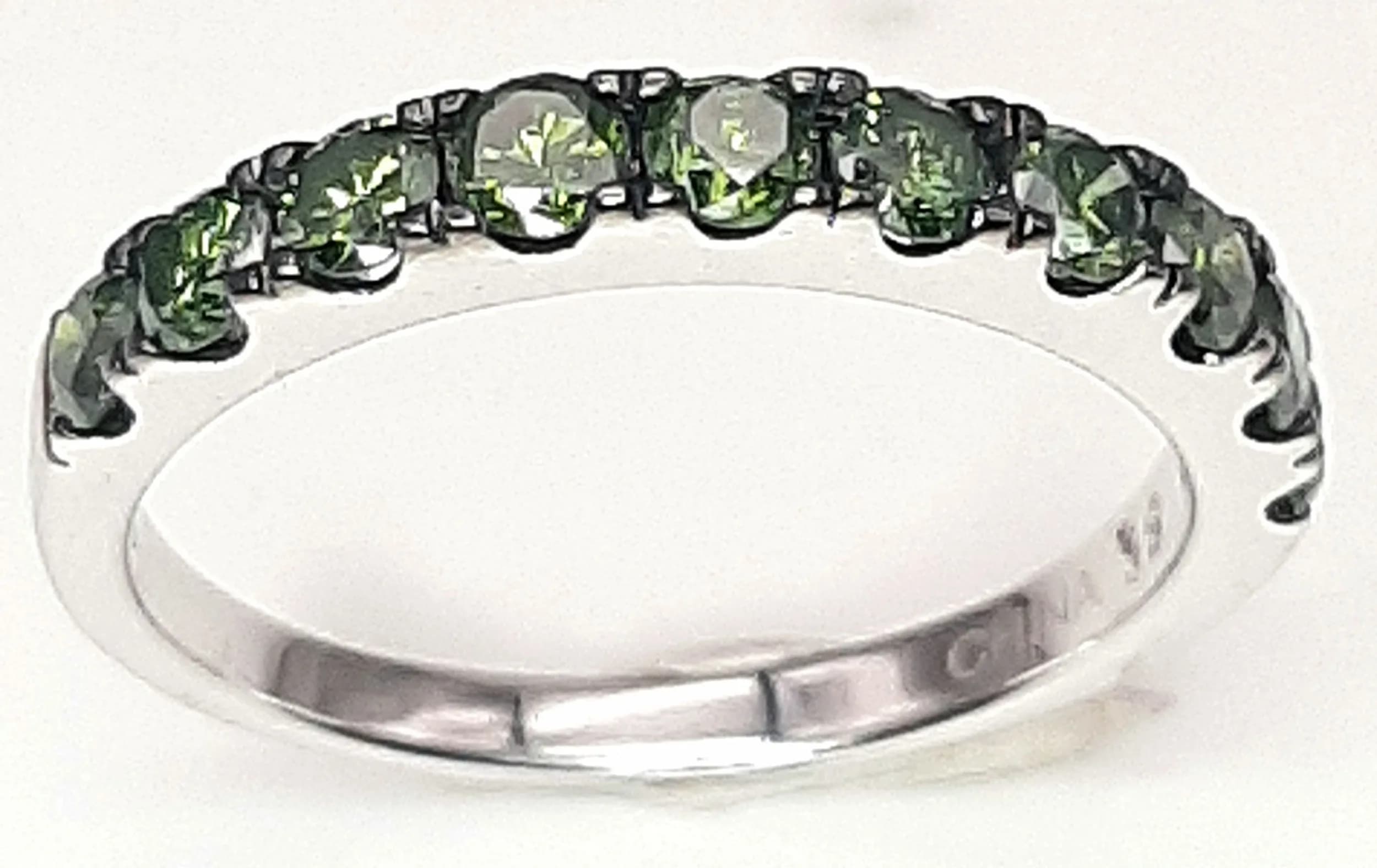 A Far Eastern Design Sterling Silver and Green Diamond Ring Size P1/2. The Ring is set with Ten 2mm Round Cut Green Diamonds, approximately 0.30 carat total and weighs 2.35 grams.