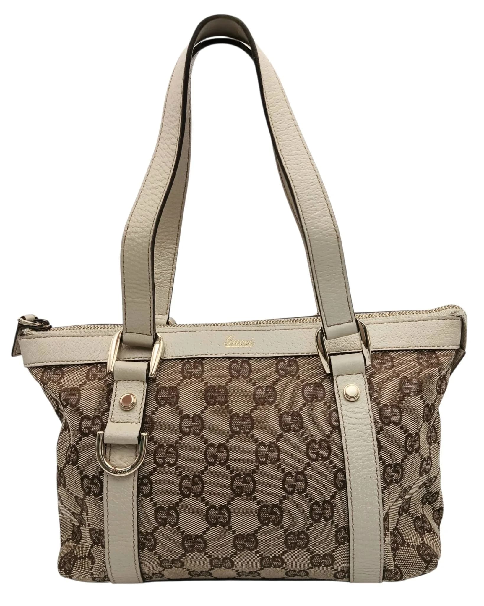 A Gucci Monogram Small Abbey Tote Bag. Beige and brown GG monogram canvas exterior with cream leather trim, gold-tone hardware, double leather shoulder handles and protective base studs. Zip-top closure opens to a dark brown textile interior with one main compartment, a zipped inner side pocket and an open inner side pocket. Approx. 25cm length x 17.5cm height x 9cm depth. Comes with certificate of authenticity. Signs of tarnishing to the zip puller, but overall in good condition. Please see photos or request a condition report. Ref: 29711.