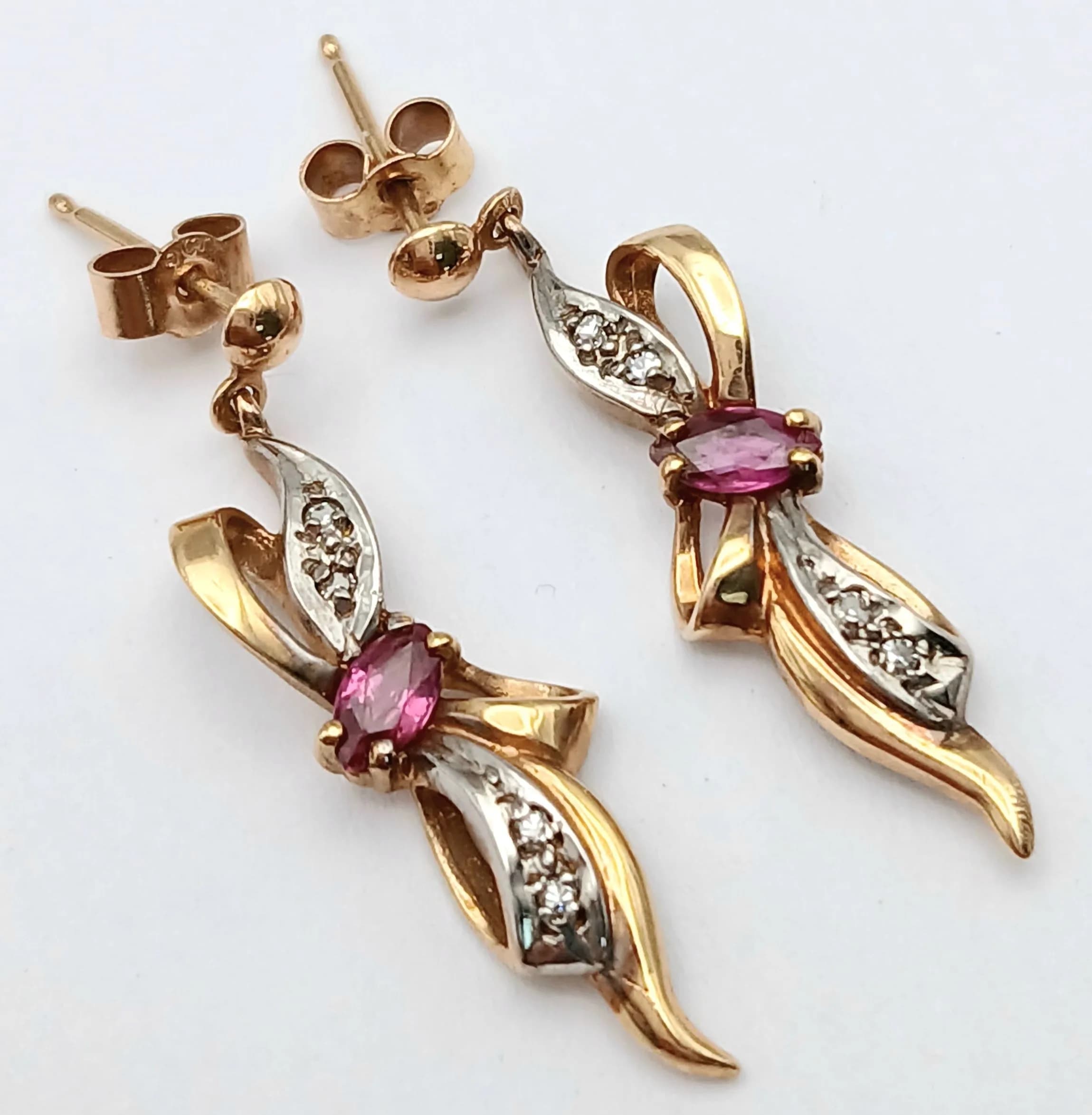 A Pair of 9K Yellow Gold Ruby and Diamond Drop Earrings in Bow Form. 3cm drop. 1.95g total weight.