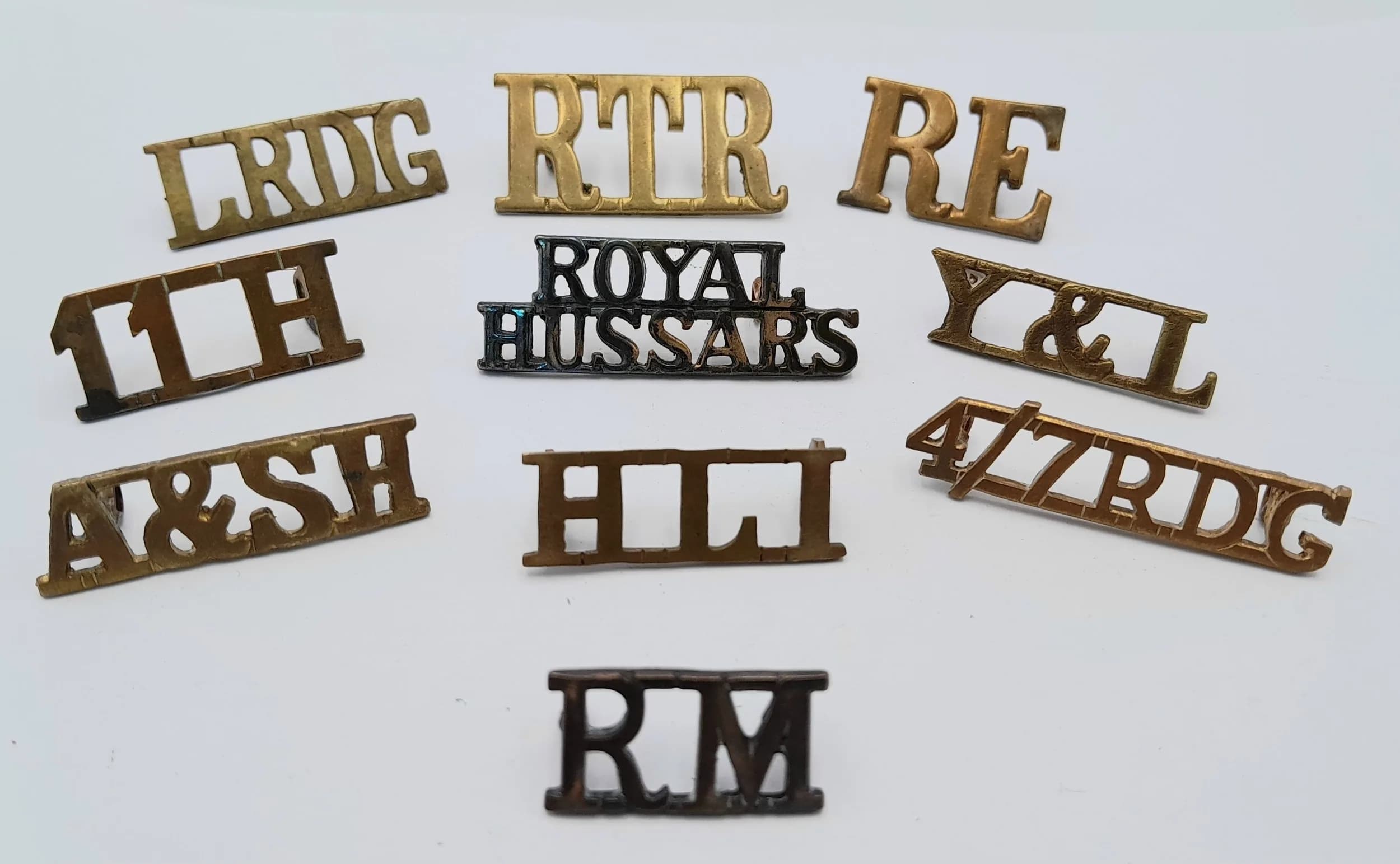 10 x British Army Brass Shoulder Titles. The LRDG has a lug missing