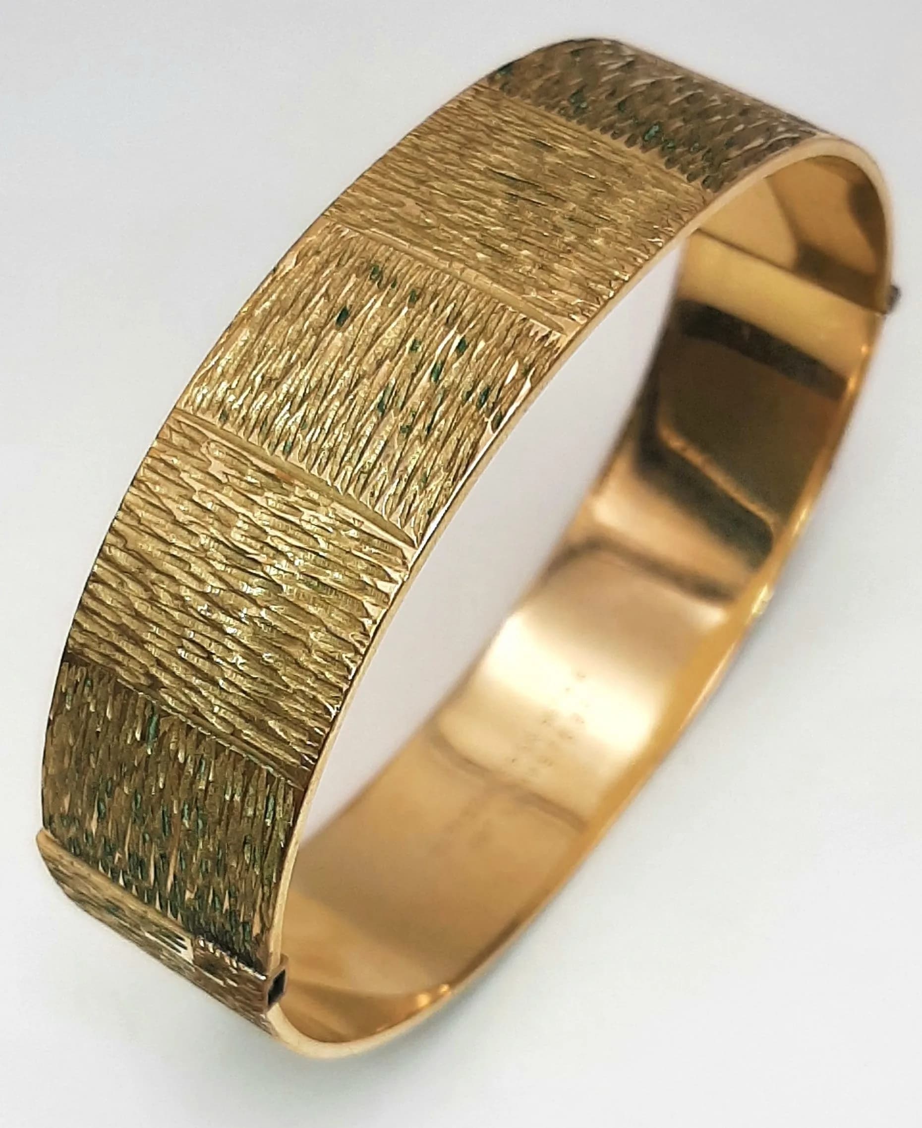A Vintage 9K Rolled Gold Bangle. 16mm width. 60mm inner diameter. 26.6g.