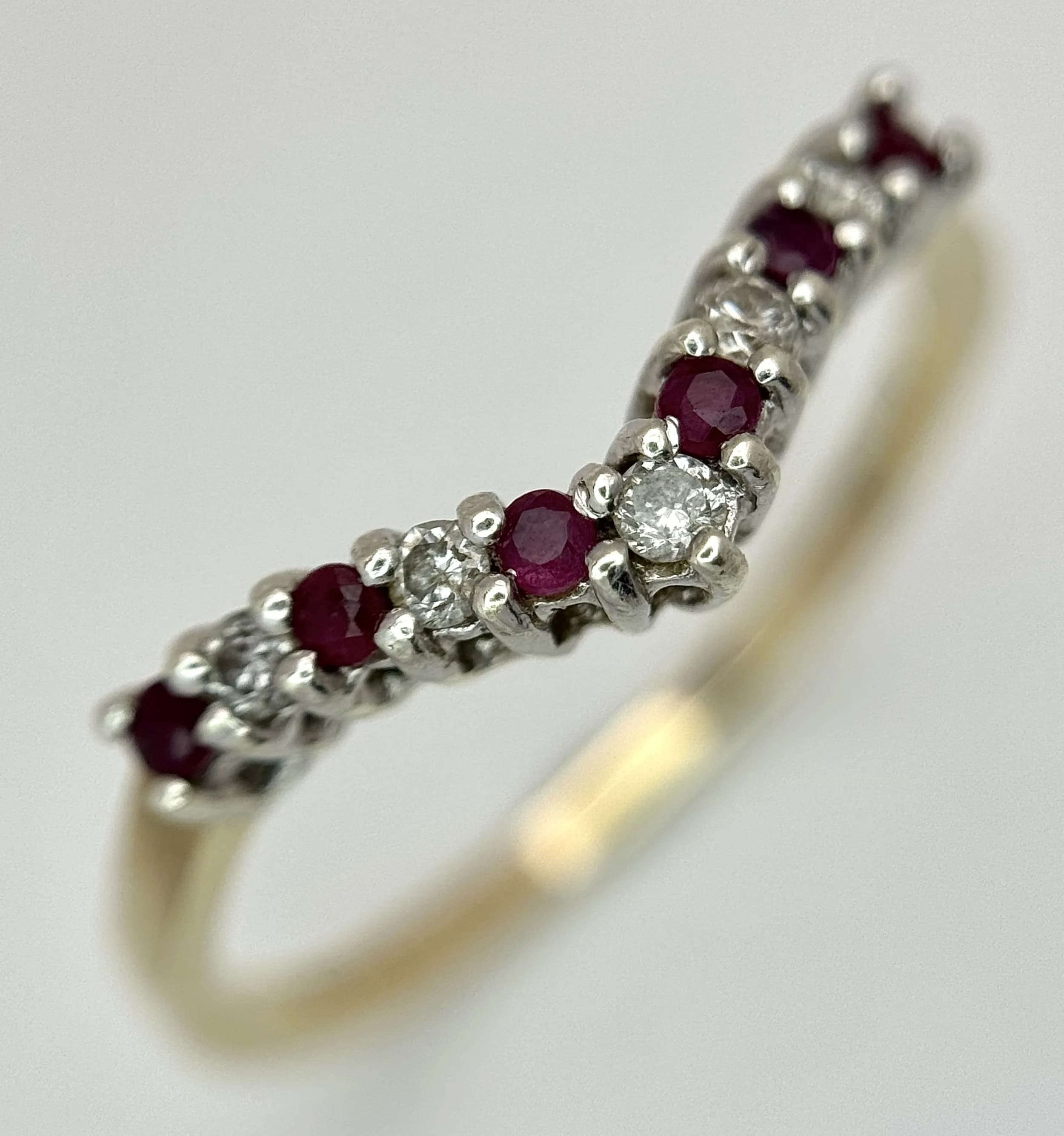 A 9K YELLOW GOLD, DIAMOND AND RUBY SET, WISHBONE SHAPED RING. 1.7G, SIZE R. SC 7021