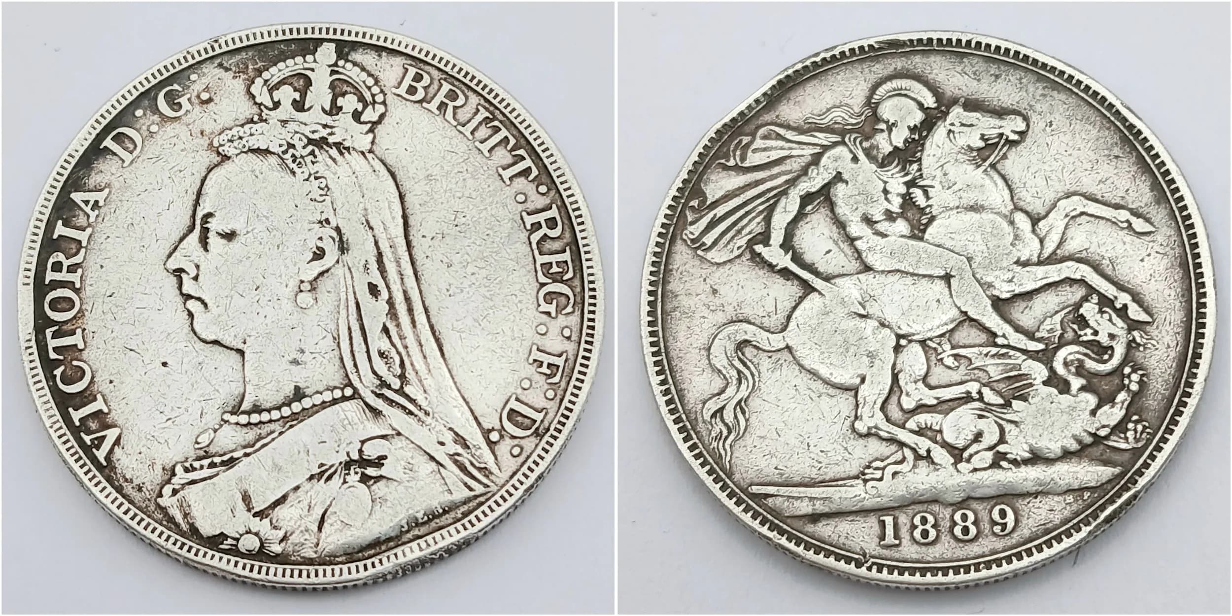 A VICTORIAN SILVER CROWN COIN DATED 1889 IN FAIR CONDITION .