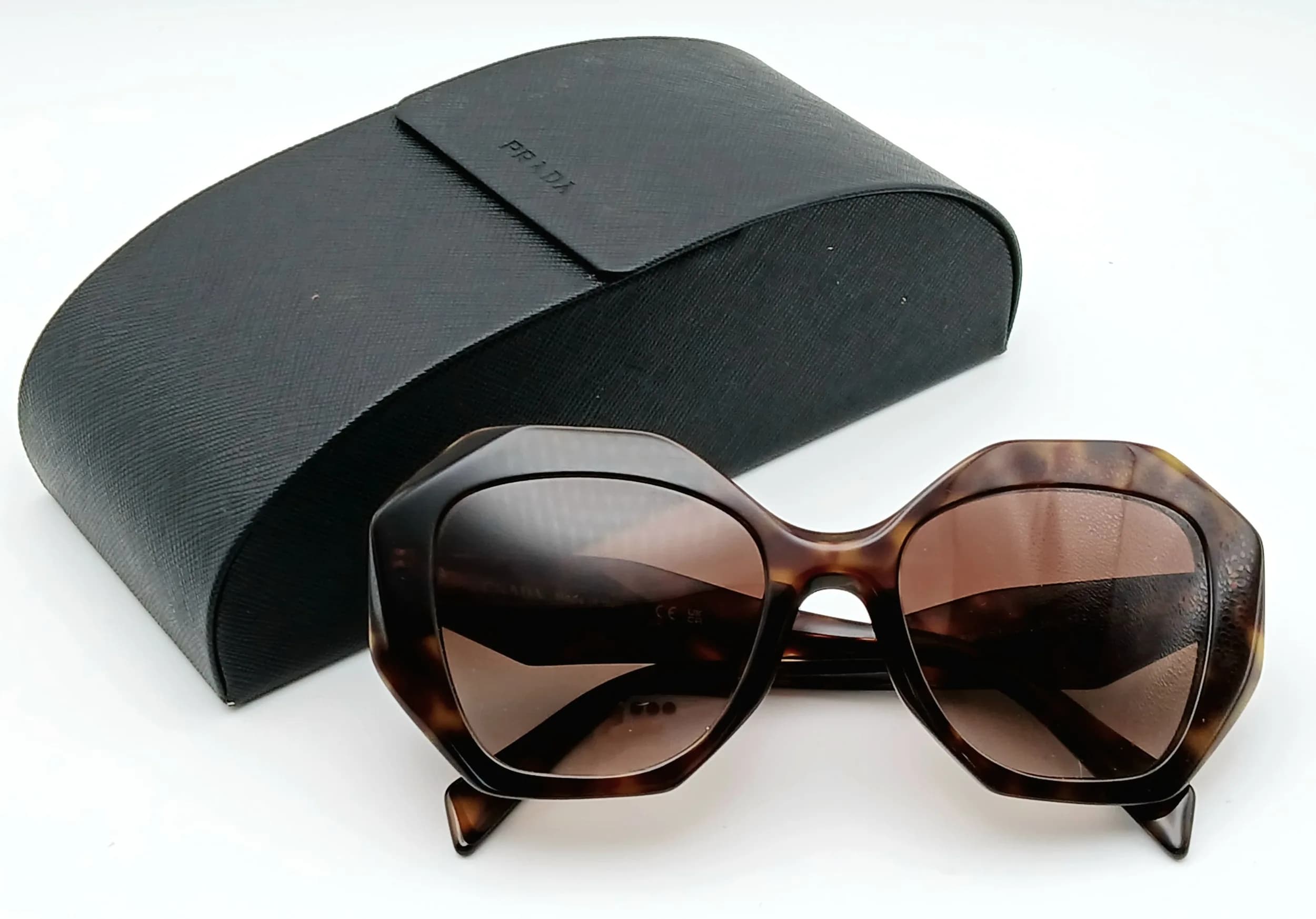 A Pair of Prada PR 16WS Irregular-Shaped Sunglasses. A Bold Geometric Acetate Frame and Brown Gradient Lenses. Comes with case. Ref: 29781.