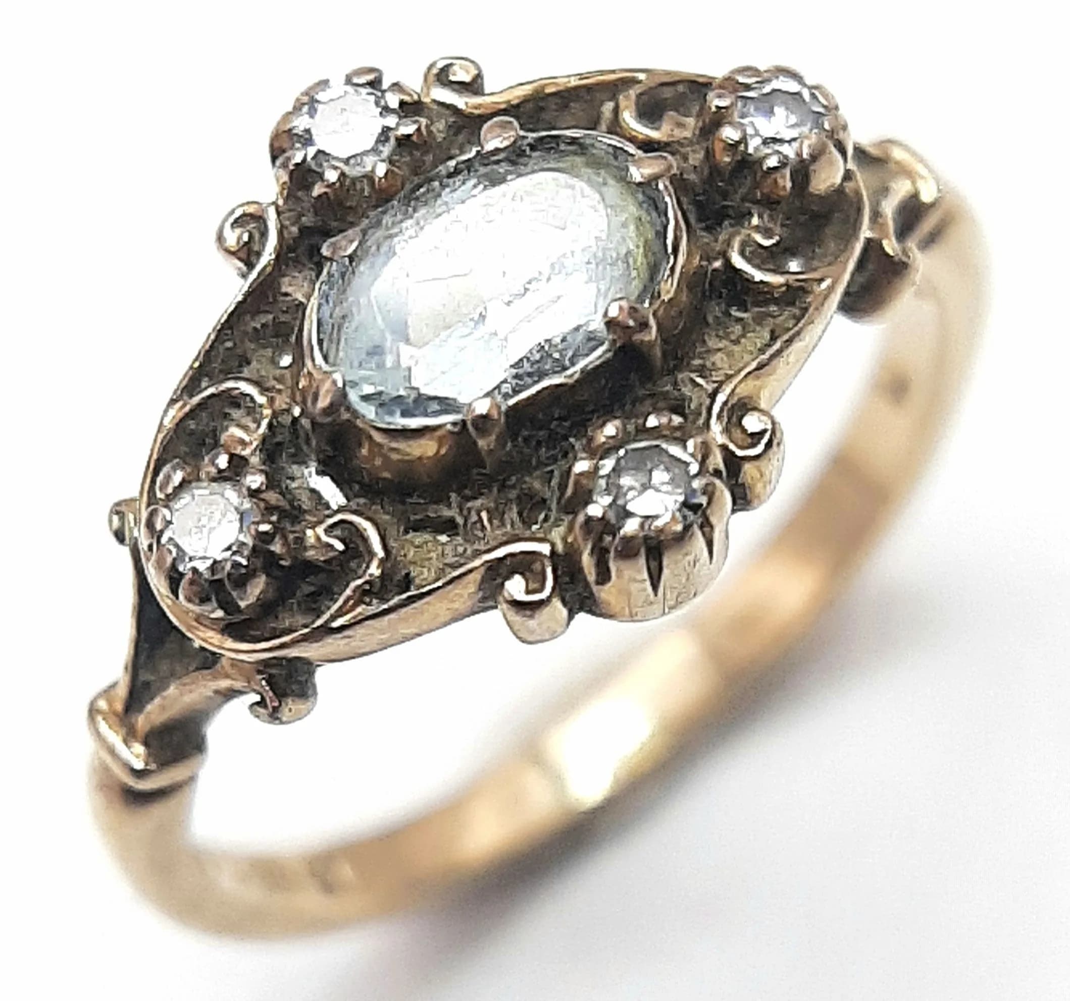 An Antique Style 9K Yellow Gold Aquamarine and Diamond Ring. Oval cut 0.5ct centre aquamarine with compass point diamond markers. Size L. 2.45g total weight.