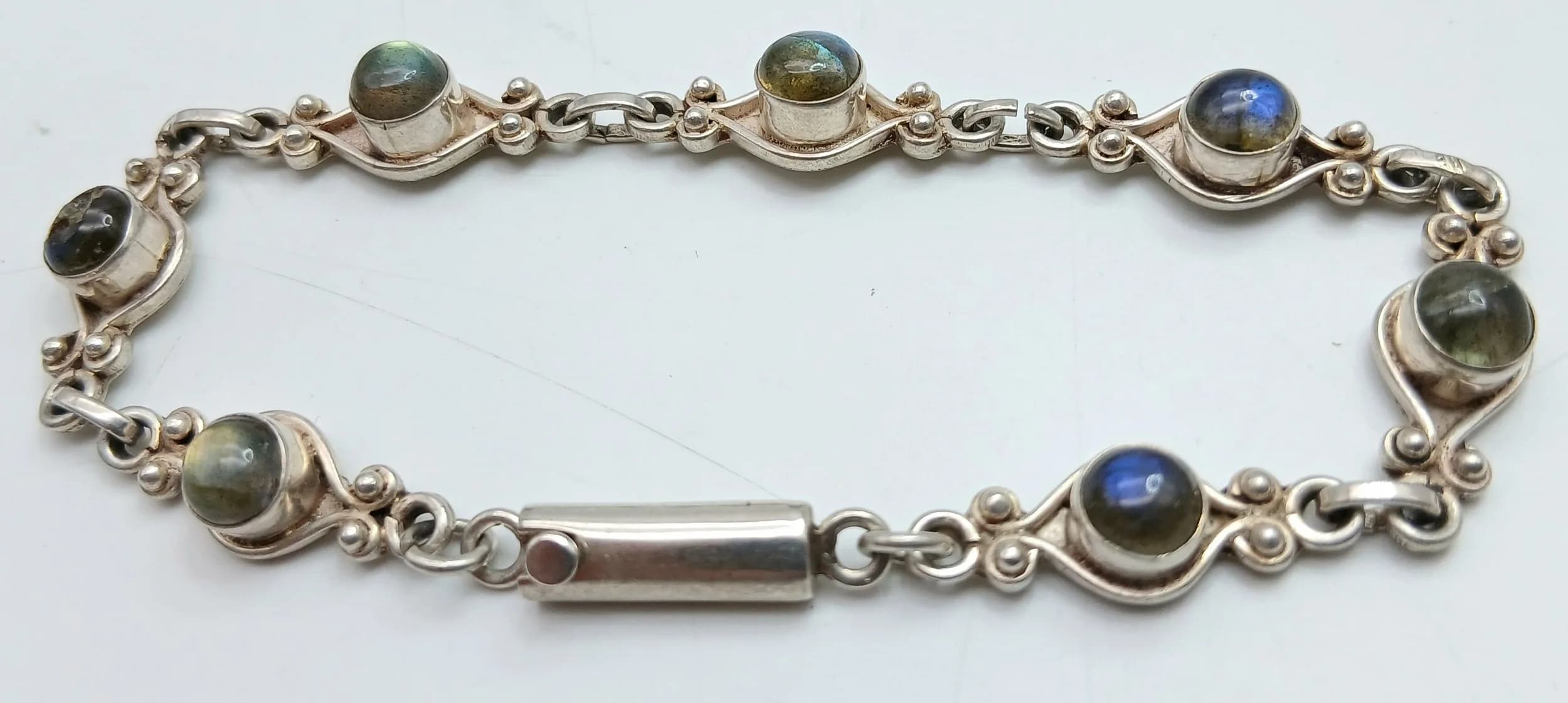 A Vintage Sterling Silver Labradorite Cabochon Bracelet-20cm Length. Set with Seven Round Cut 5mm Diameter Labradorite Cabochons. Gross weight 12.72 grams.