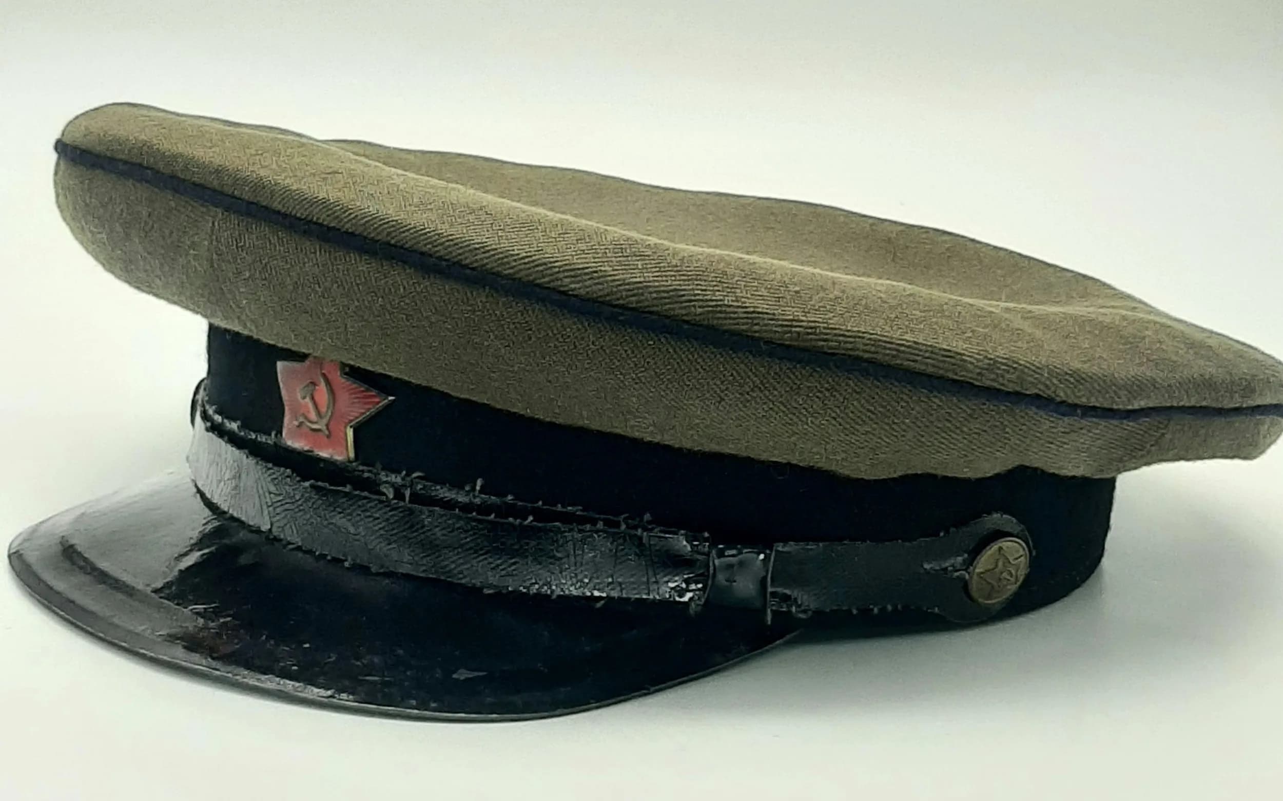 A Vintage Soviet Military Officers Peaked Visor Cap. Red hammer-and-sickle star cockade to front.