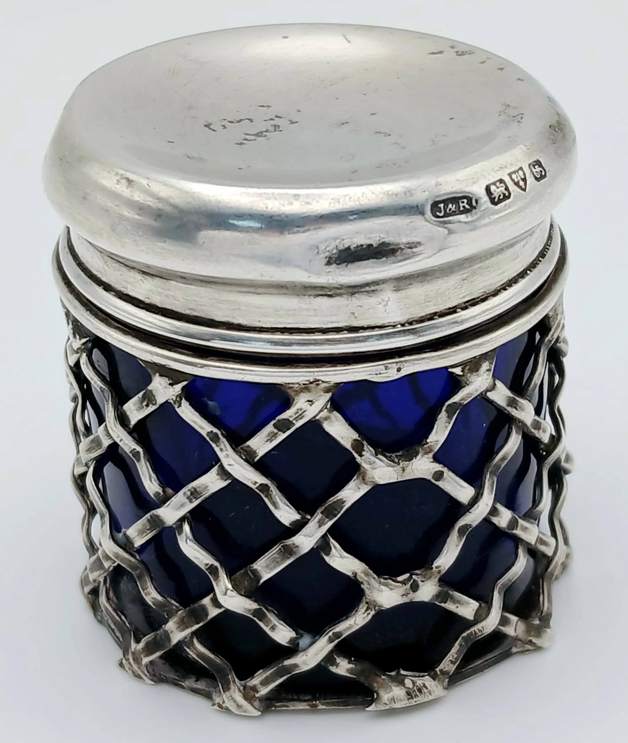 An Antique Sterling Silver and Blue Cobalt Glass Small Lidded Pot. Lattice bodywork. 1909 Chester hallmarks. 4.5cm tall. 66g total weight.