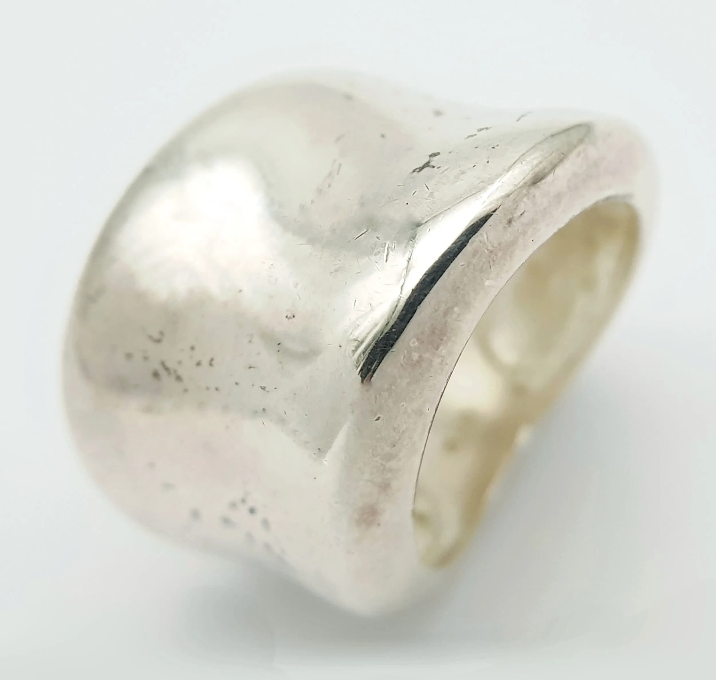 A 925 Silver Wide Band Ring. Polished wide band with a softly curved design. Hallmarked 925. Ring size L. Total weight 12.71 grams.