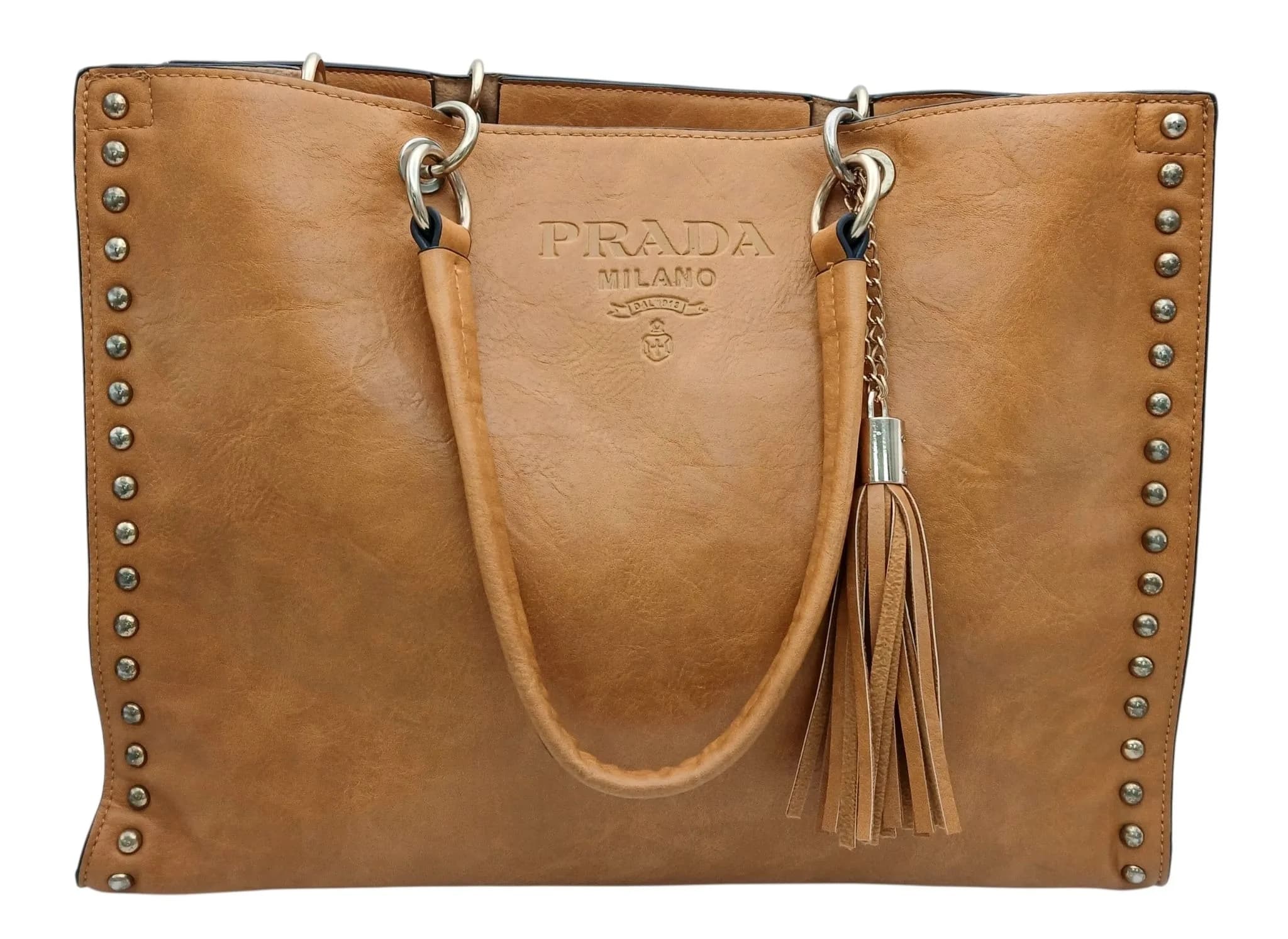 A PRADA TAN LEATHER HANDBAG WITH TWIN ROLLED LEATHER HANDLES AND STUD EDGING TO BOTH SIDE, IN SOFT SAFFIANO LEATHER. A FEW MARKS FROM USAGE. 38 X 28cms