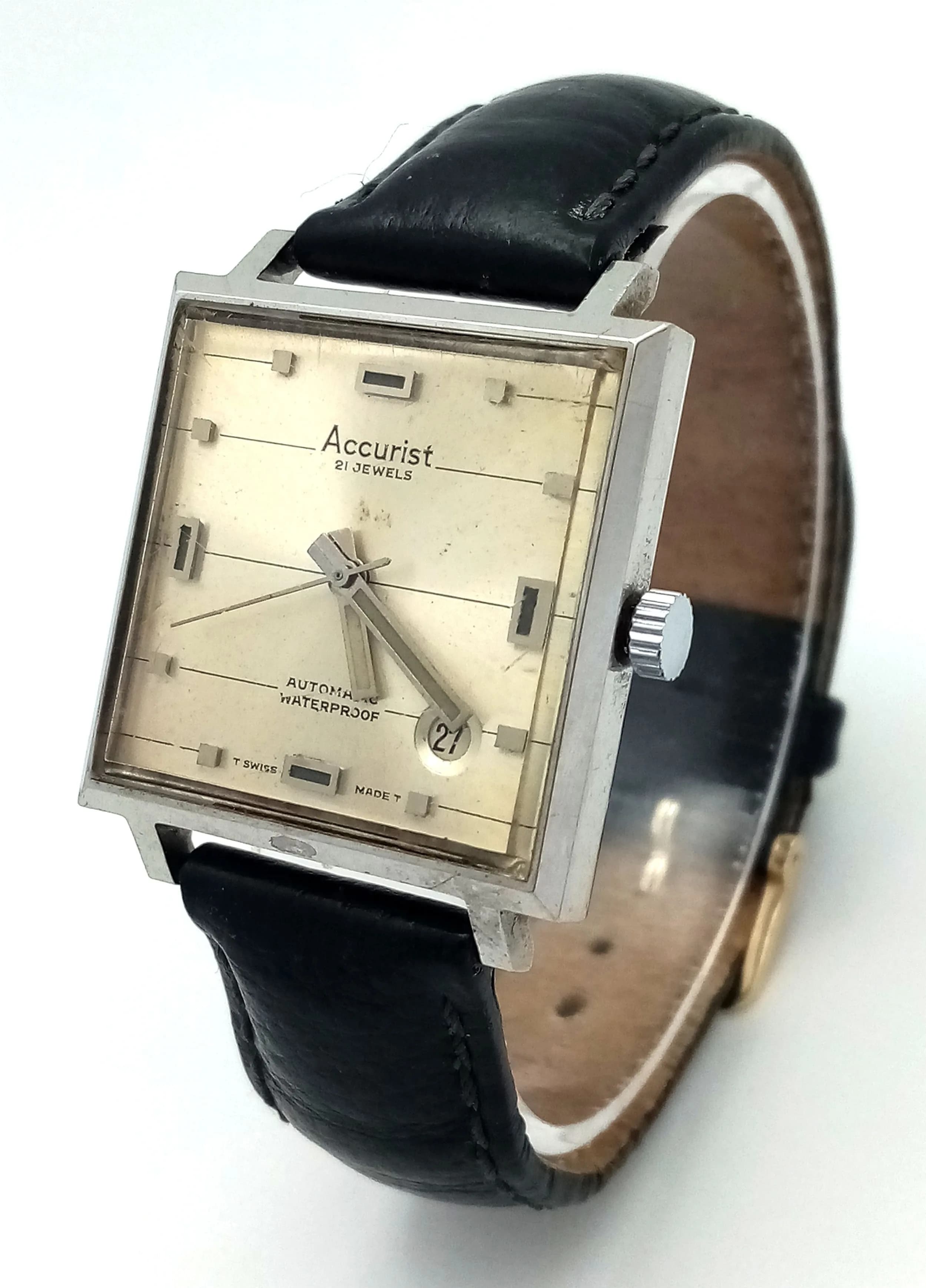 A Vintage Accurist Automatic Gents Watch. 21 jewels. Black leather strap. Square stainless steel case - 30mm. Silver tone dial with date window. In working order.