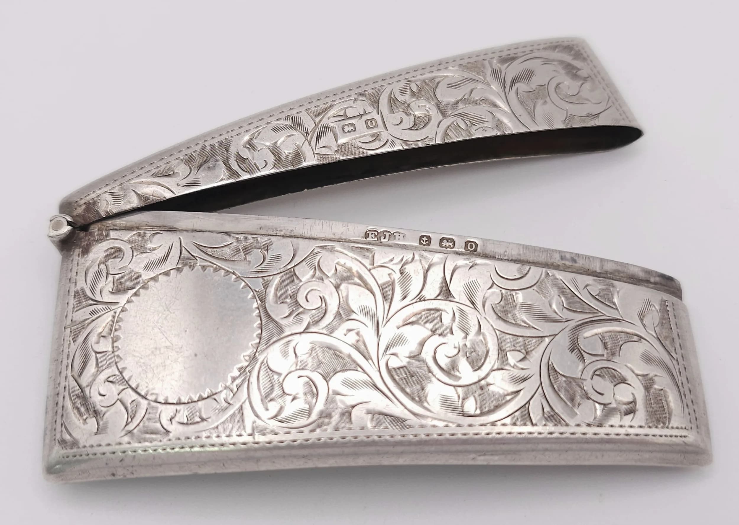 A VICTORIAN CARD CASE WITH HAND CHASED DECORATION TO BOTH SIDES. HINGE STILL WORKS WELL. 34.8gms 8.5 X 4CMS