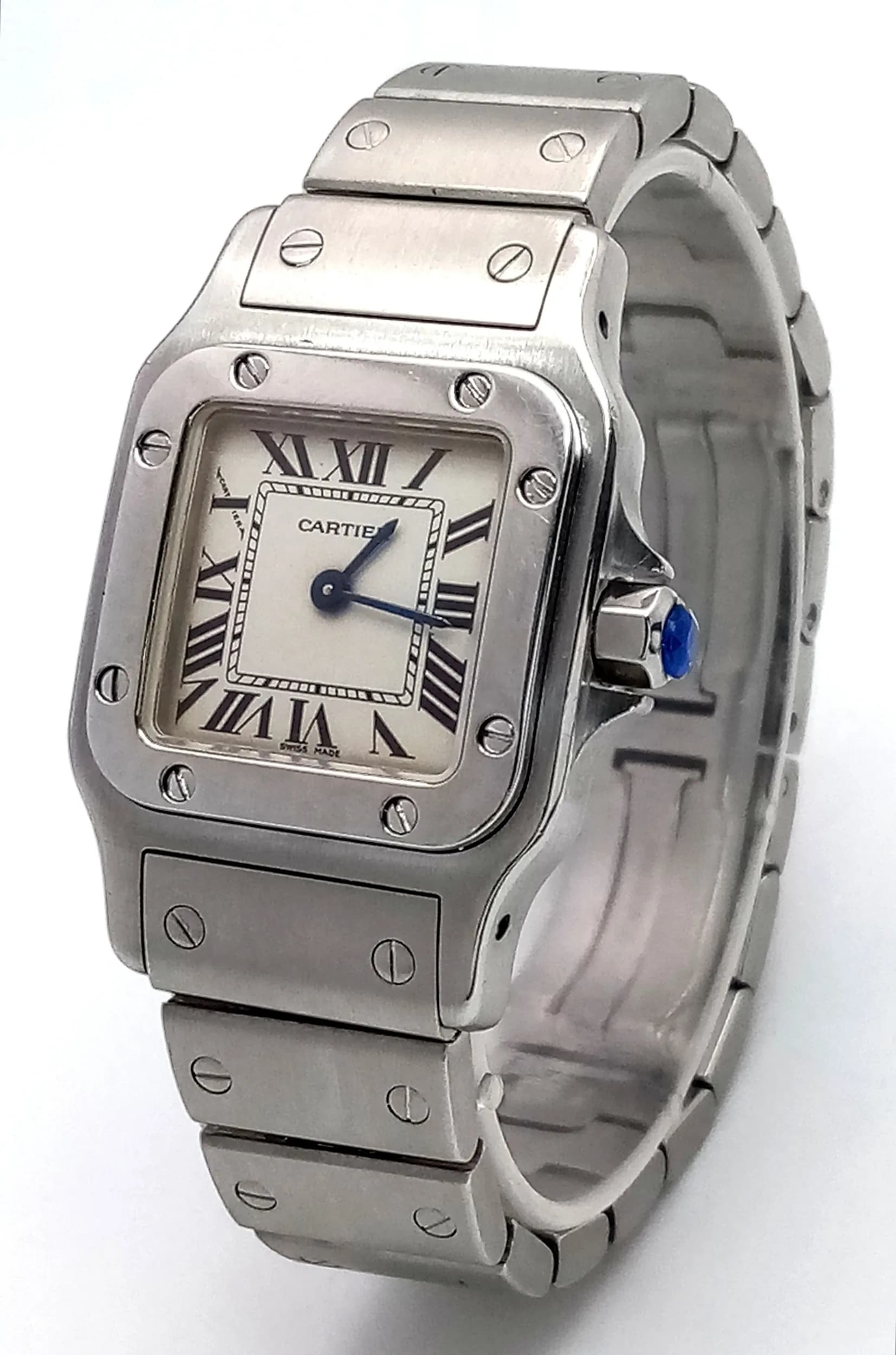 A Cartier Santos Galbee Quartz Ladies Watch. Model 1565. Stainless steel bracelet and case - 24 x 35mm. White dial with Roman numerals. Blue sapphire tipped crown. In working order. Comes with spare links, box and papers. Ref: 029787.