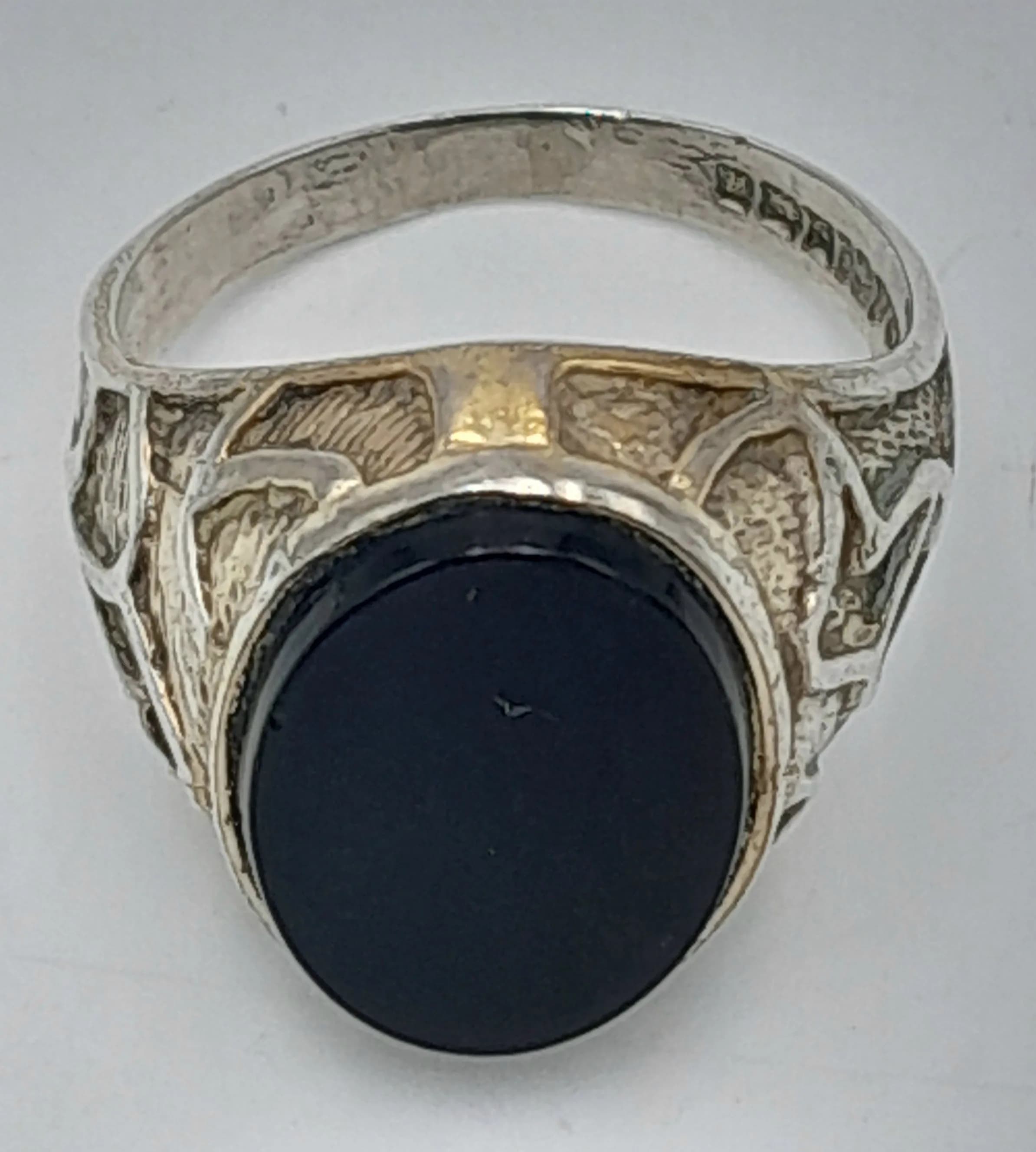A Vintage Hallmarked 1975 Sterling Silver Black Onyx Detailed Signet Ring Size R. The Ring measures 1.6cm Length at the Crown and has a gross weight of 5.42 grams.