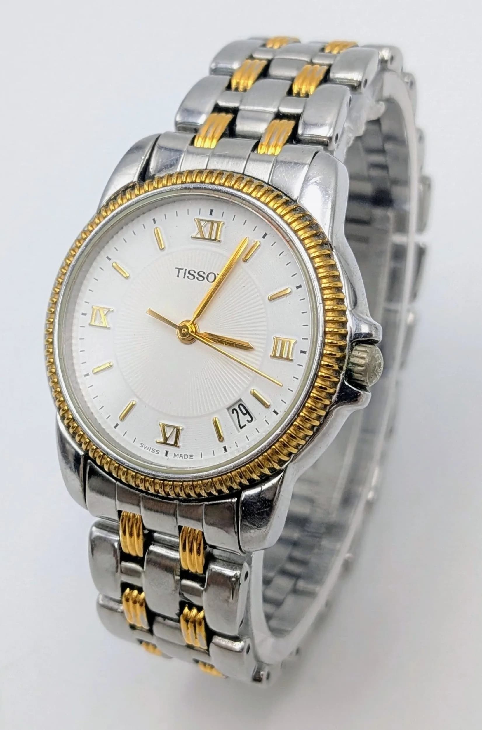 A Tissot Pack Quartz Unisex Watch. Two tone bracelet and case - 33mm. White dial with date window. In working order.