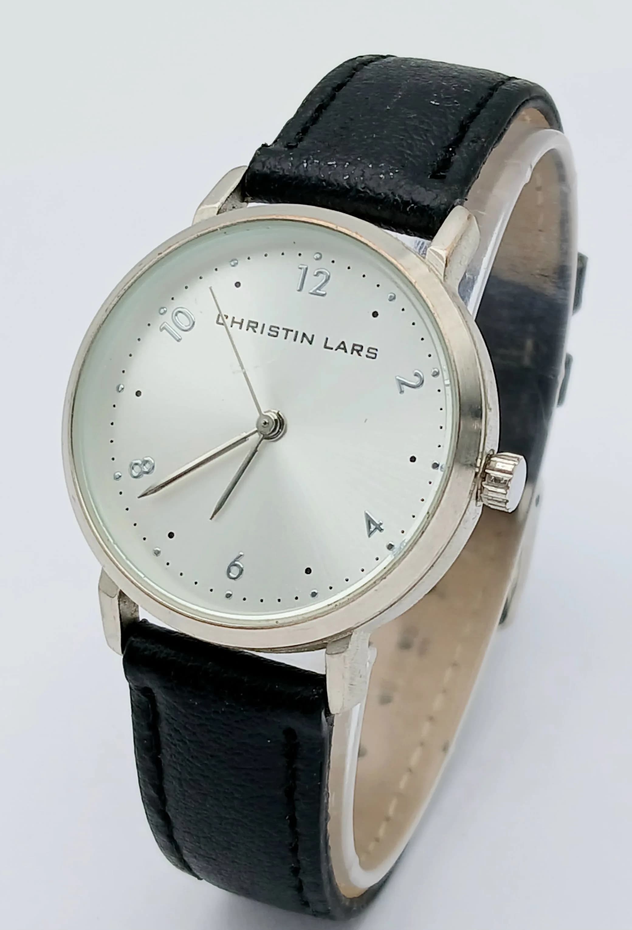 A CHRISTIN LARS, STEEL CASED, BLACK LEATHER STRAP WATCH. IN FULL WORKING ORDER. NEW BATTERY FITTED RECENTLY. S/A 1324 - 2