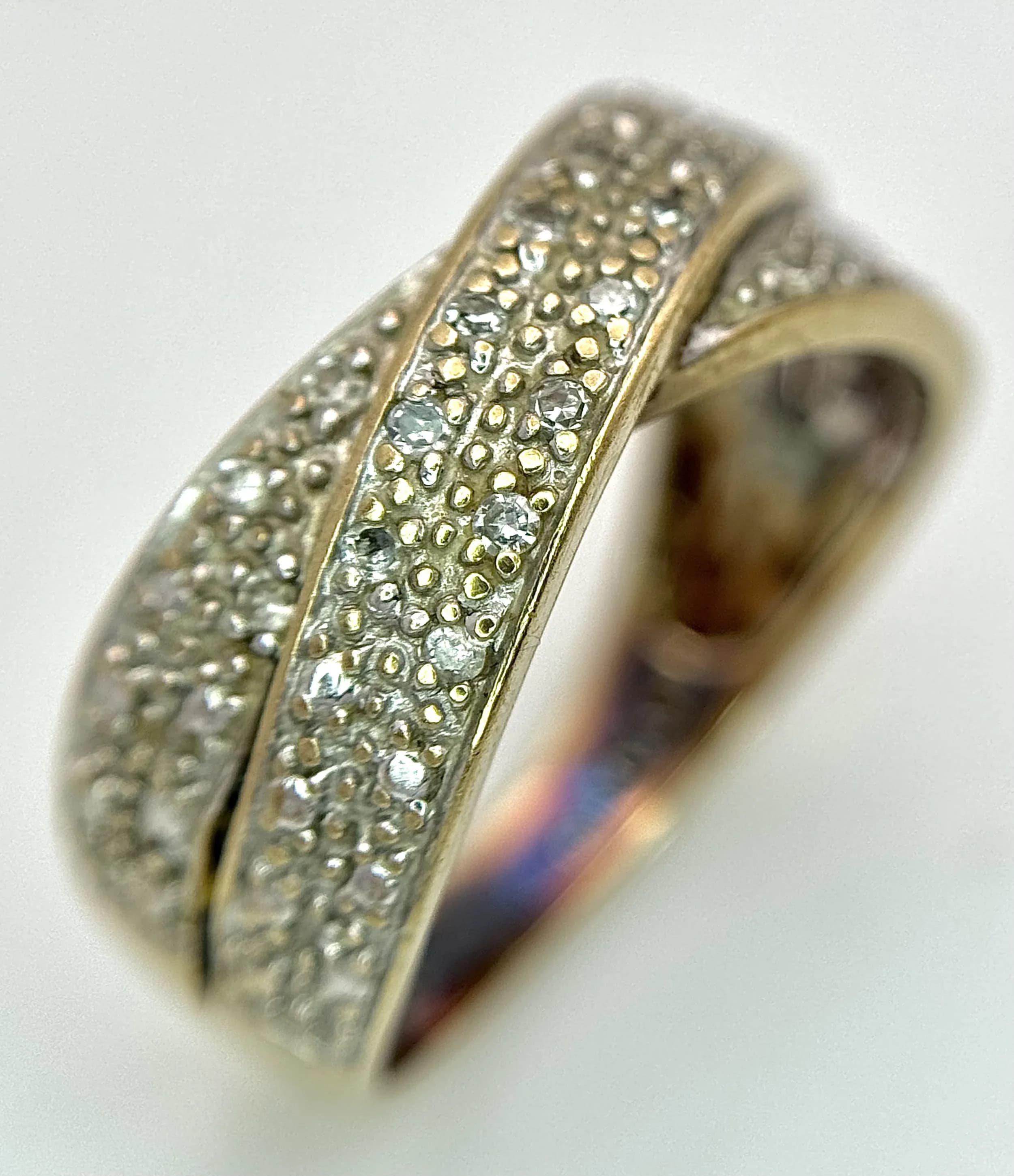 A 9K Yellow Gold Diamond Cluster Crossover Ring. Size L 1/2. 3.4g total weight.