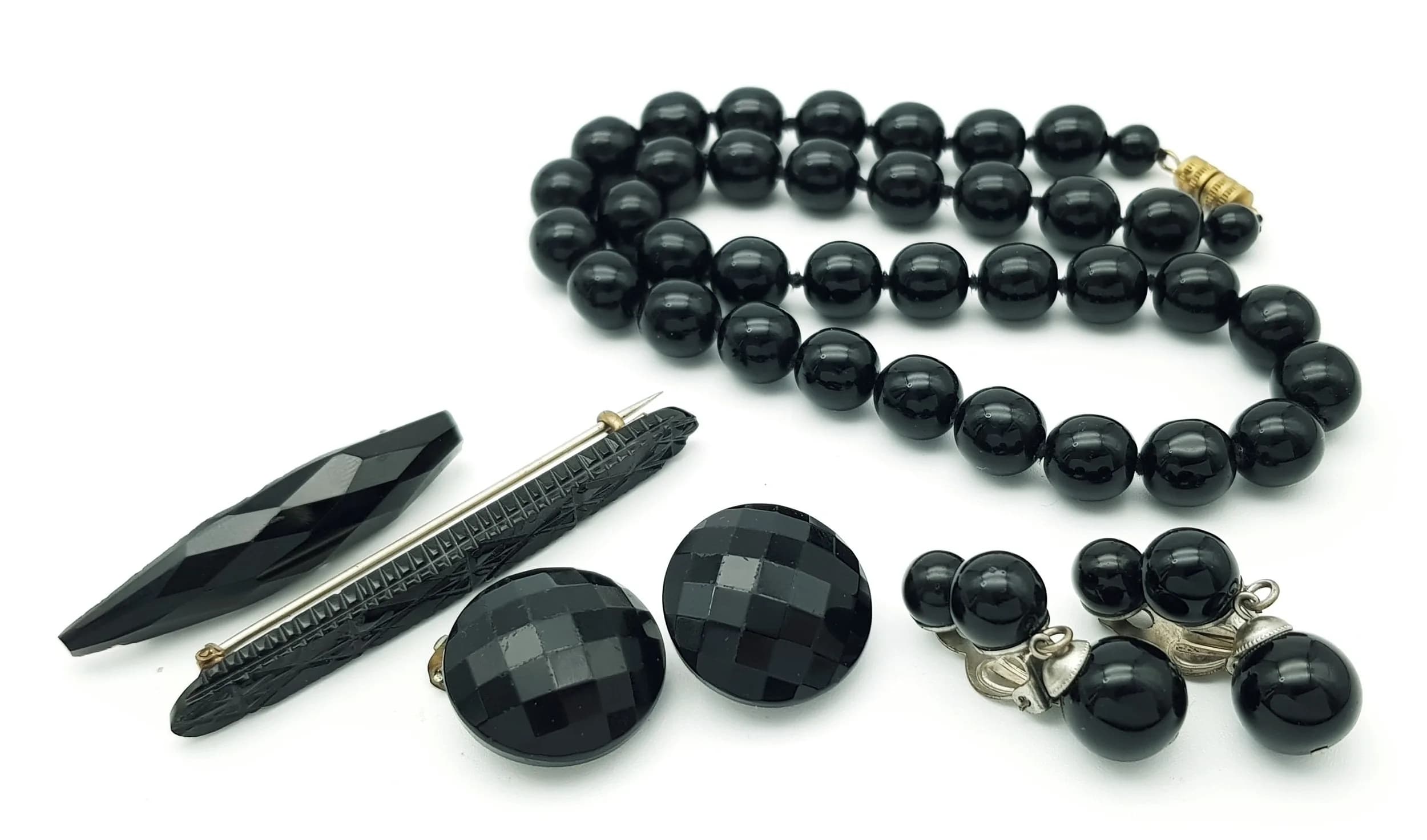 A Parcel of Vintage and Antique French Jet Jewellery. Comprising: 1) Two Bar Brooches, 2) Two Pairs of Clip-on Earrings and 3) 42cm Screw Clap Round Bead Necklace.