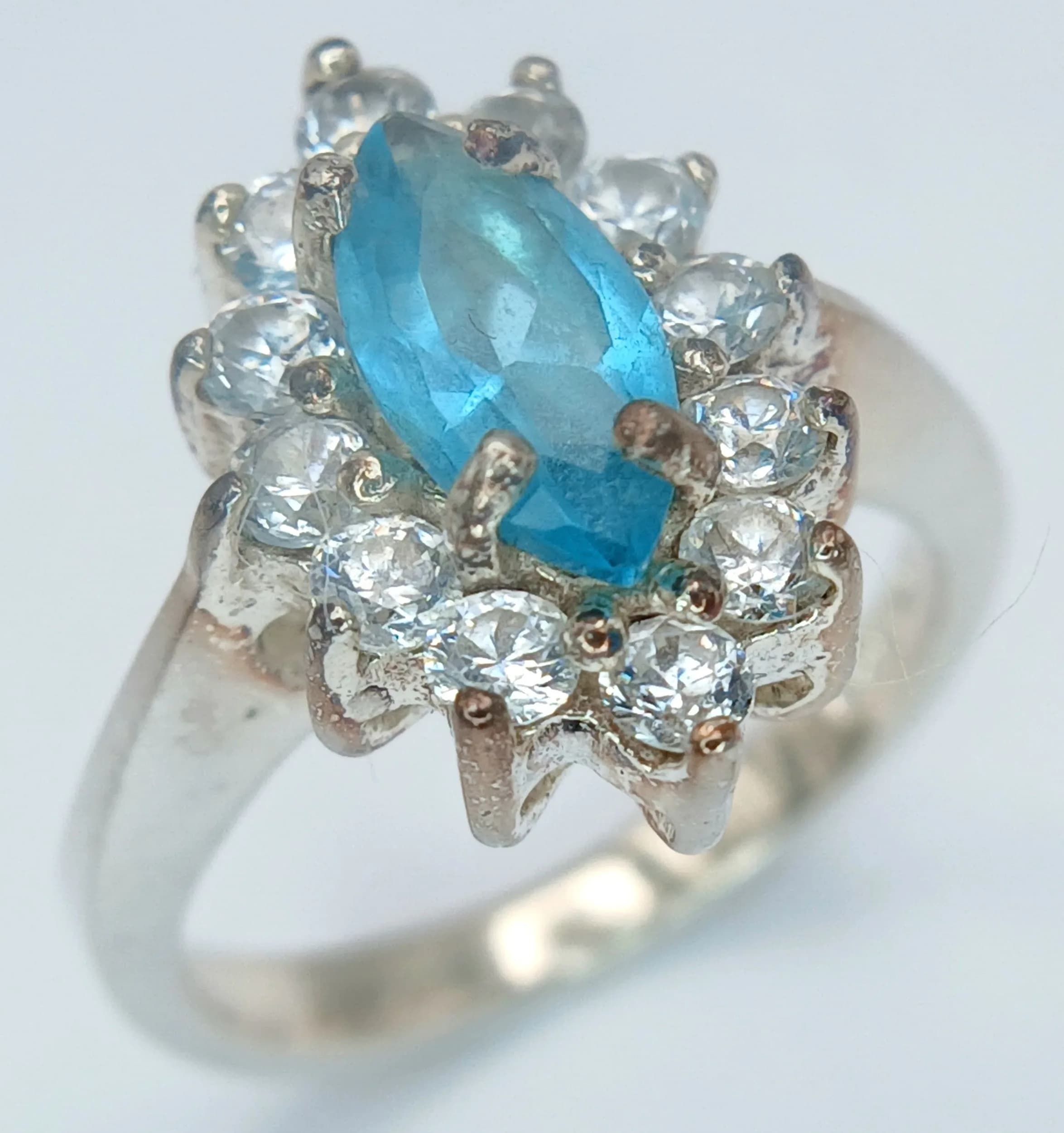A Sterling Silver Blue and White Stone Cluster Ring Size L. The Ring measures 1.5cm Length at the Crown and has a gross weight of 4.57 grams.